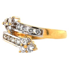 Anello bypass con diamante e freccia in oro giallo e bianco 18 carati