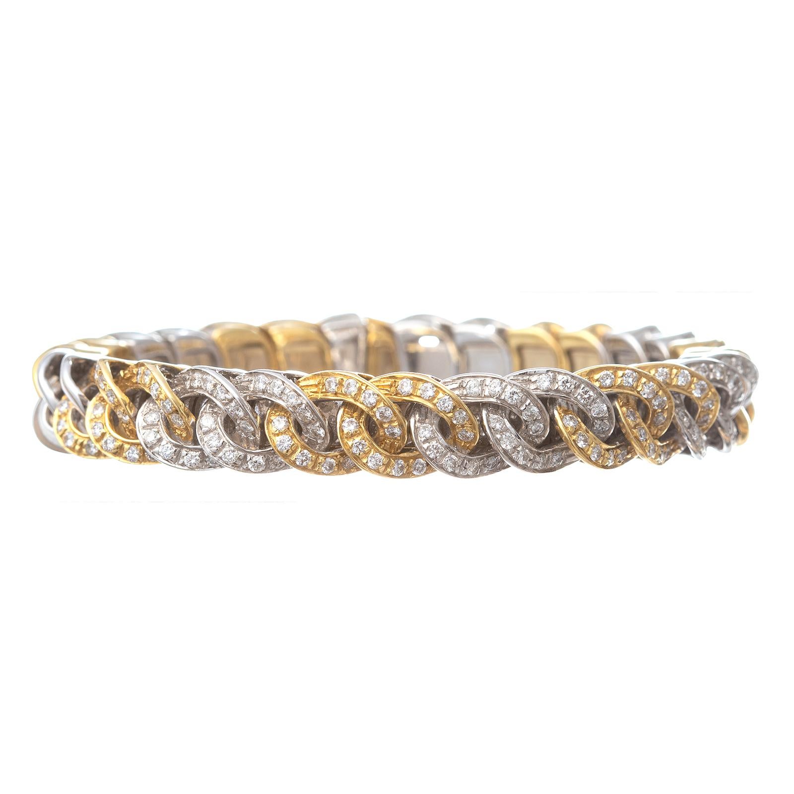 Flexible curb link design cuff bracelet in 18k yellow and white gold.  Alternating two white gold and two yellow gold links with the front accented by round brilliant-cut diamonds.  120 diamonds weighing approximately 2.40 total carats (G-H color,