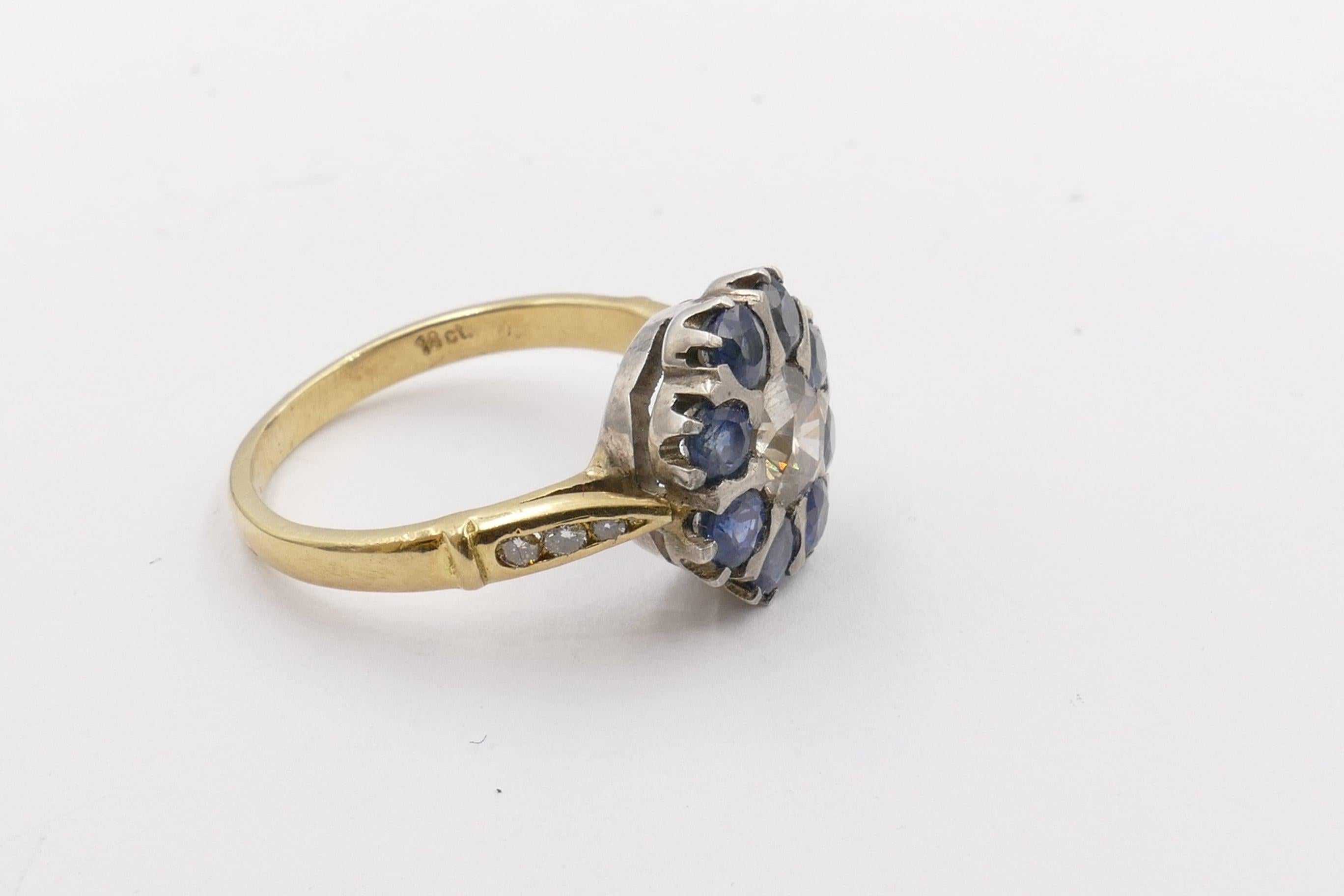 This Ring is a rather lovely reverse on the traditional Daisy Ring which has the Gem Stone in the centre and is surrounded by Diamonds.
This Ring has the opposite composition with the Diamond as the centre stone flanked with 8 good sized, high