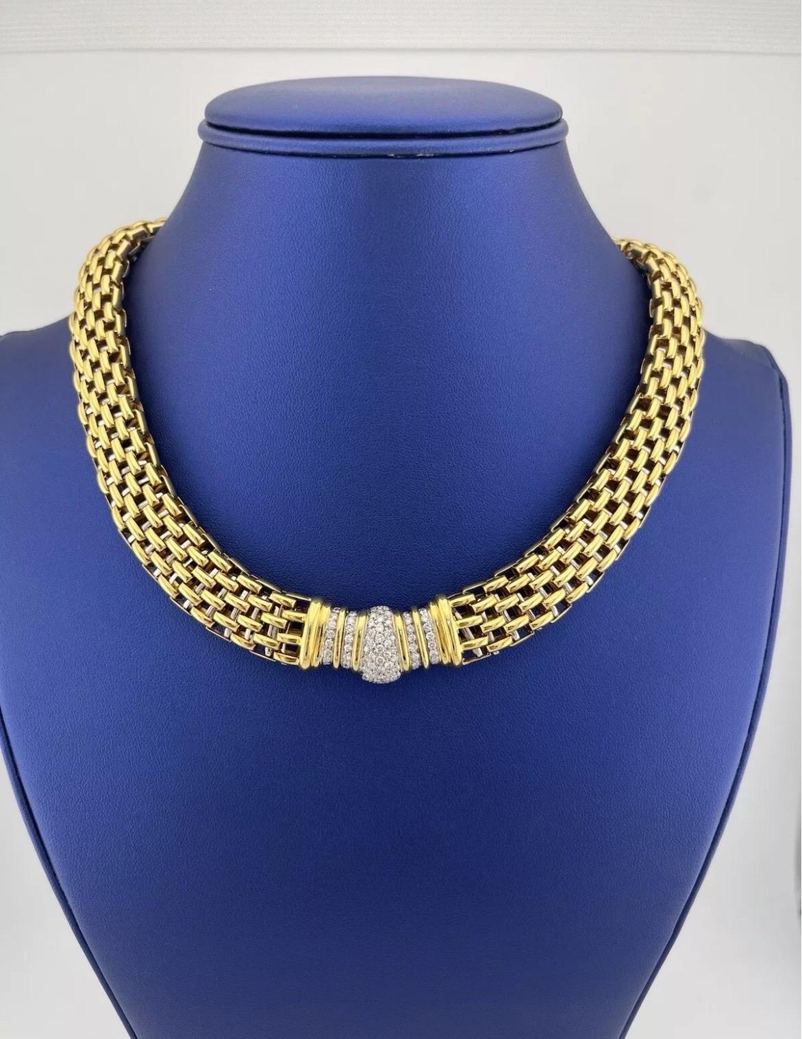 Make a statement of timeless elegance with this exquisite 18kt white and yellow gold necklace. Featuring a bold, intricately woven design, this piece is the perfect balance of sophistication and glamour. At its center, approximately 2.00 carats of