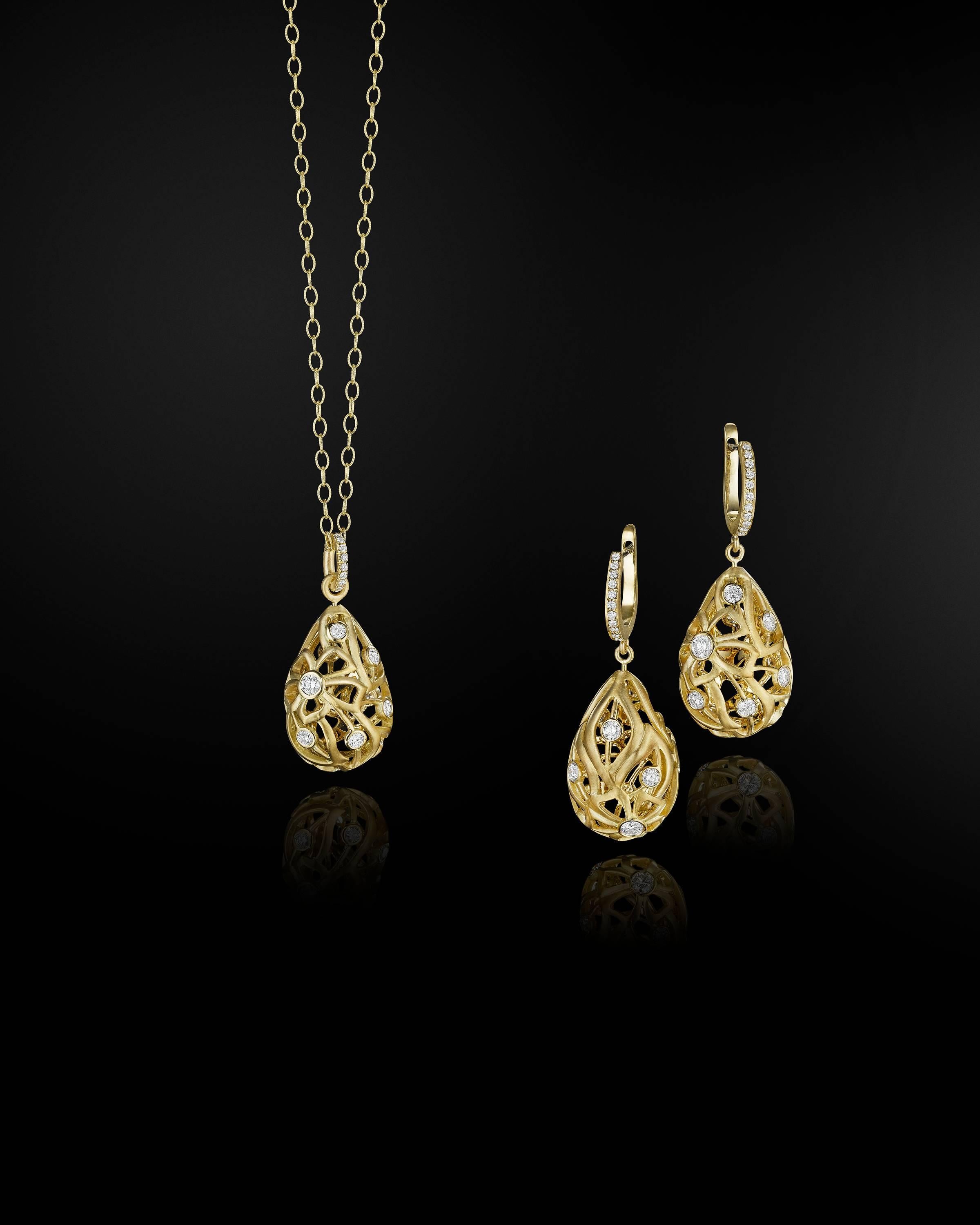 This romantic, floral pendant necklace made in 18k gold features .58 carats of dazzling GH-VS round diamonds set in a sultry three dimensional pear shape.  The swirling floral motif pendant measures 1 inch long and features diamonds on both sides. 