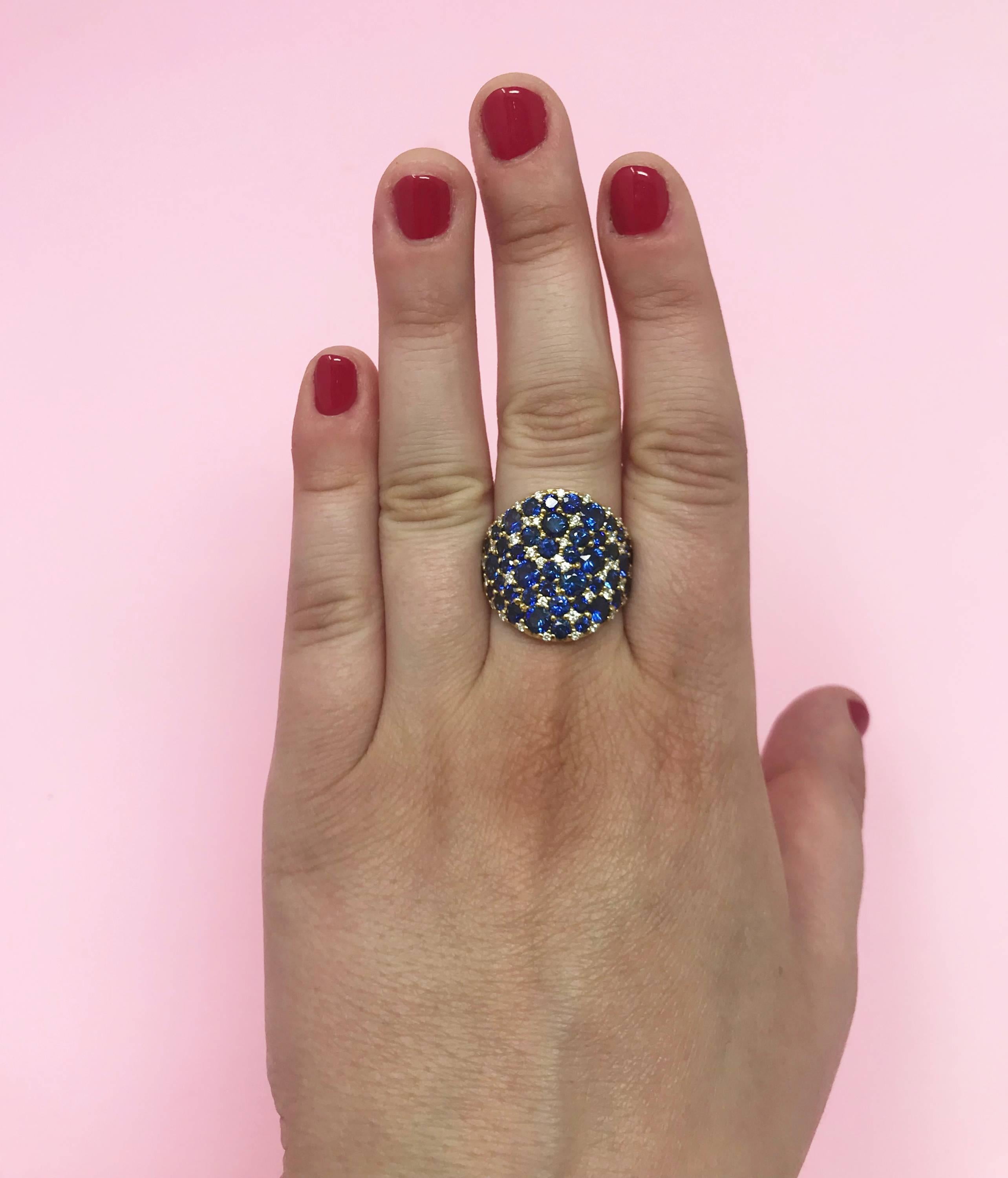 A whopping 6.18 carats of vibrant blue sapphire and .57 carats of dazzling GH-VS diamond pave are set into this 18 karat yellow gold band ring.  The ring measures 2 cm tall and tapers to a 2 mm shank at the base for comfort.  This modern classic is