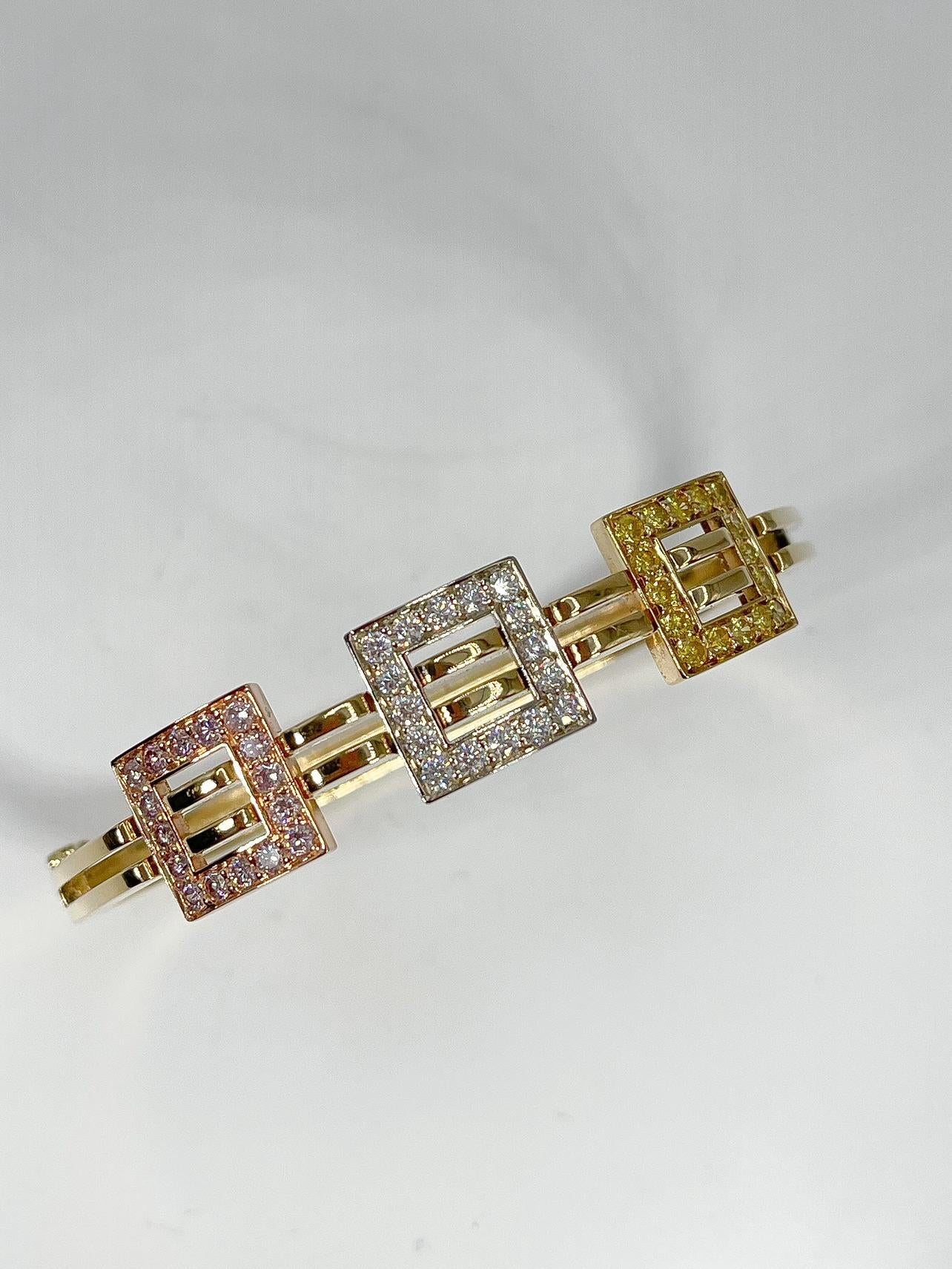 This 18k yellow gold bangle Coffin & Trout has a yellow, white, and rose gold accent with yellow white, and pink diamonds (1.90 CTW VS2 G color). The bracelet has in inside diameter of 7 inches and has a weight of 37.15 grams. Bracelet has a figure