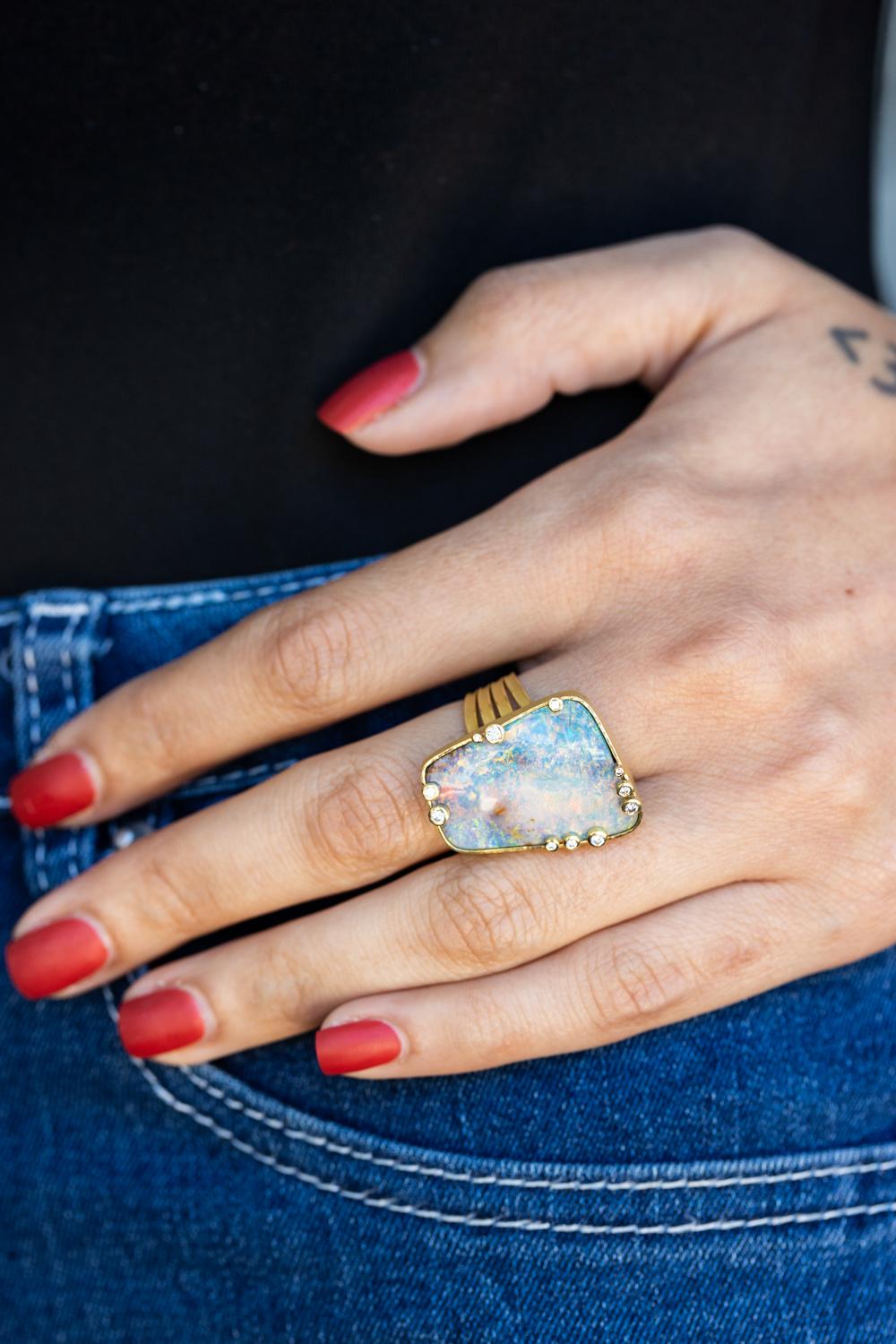 Unveil the mesmerizing allure of the Lightning Ridge Australian Opal ring, an extraordinary creation by the acclaimed designer Barbara Heinrich. This exquisite piece showcases a breathtaking 23.33-carat opal from the renowned Lightning Ridge, a gem