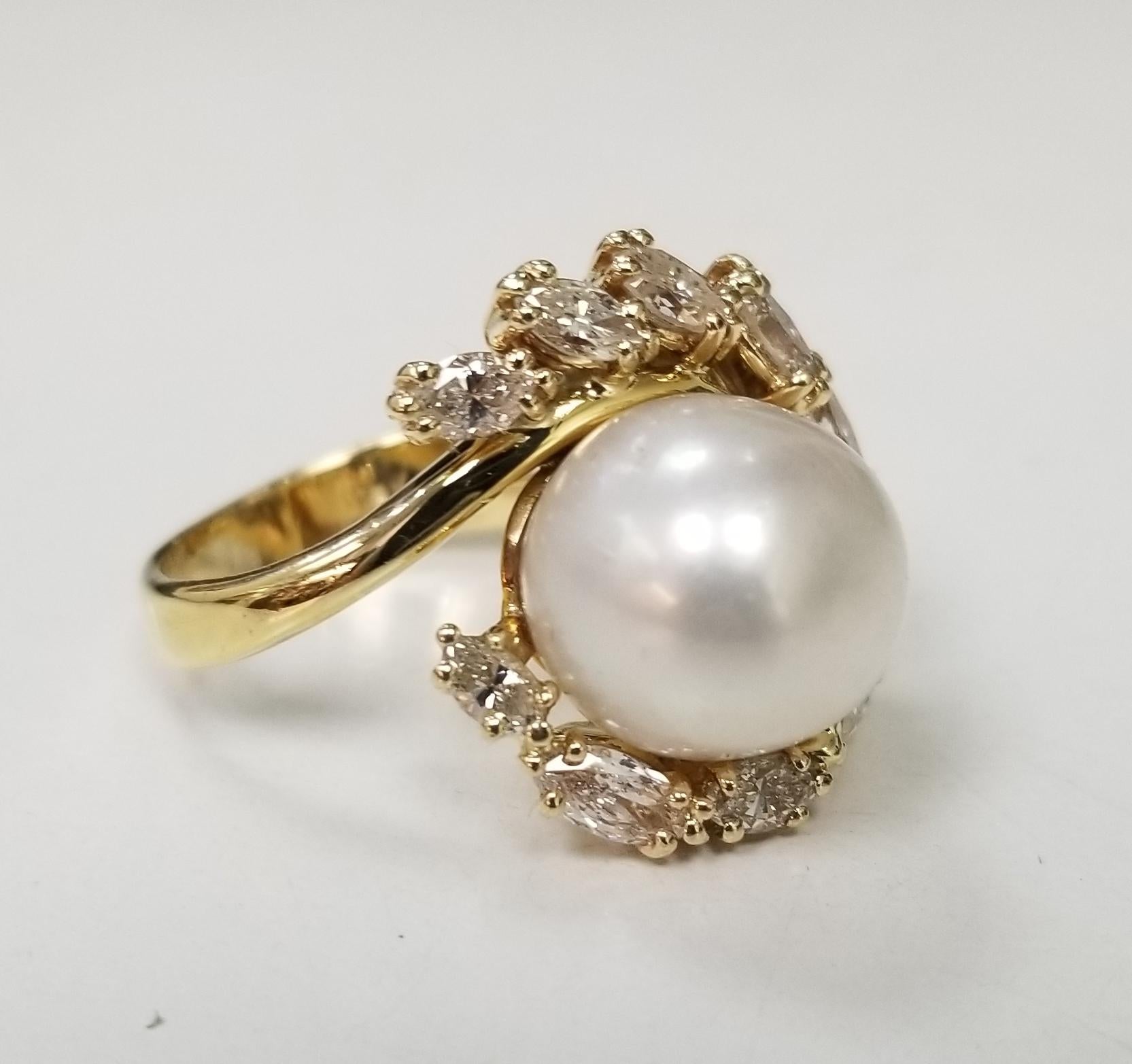 Gorgeous 18k yellow gold south sea pearl with marquise cut diamonds ring.
Specifications:
    main stone: 11.80 mm White South Sea Pearl
    diamonds: 10 marquise cut
    carat total weight: APPROX 1.50 CTW
    color: G
    clarity: VS1  
    metal: