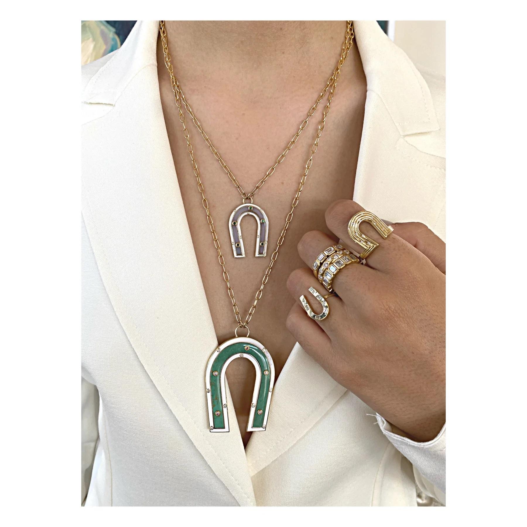 The Manifest collection reminds us to keep our thoughts aligned with all that our heart desires. A Talisman by design, this gorgeous Green Turquoise Inlay necklace boasts .10 tc Pink Sapphire, .18 tc diamonds and White Enamel. Pendant dimensions are