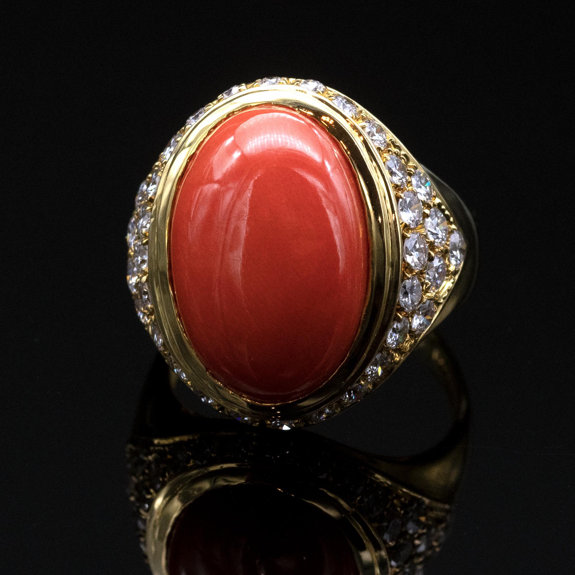 Elegant 18 karat yellow gold cocktail ring showcasing an oval coral measuring ± 17 x 16.5 mm is set in its center highlighted with approx 1.12 carat of white diamonds  (FG VS).
A matching necklace and earring are also available
