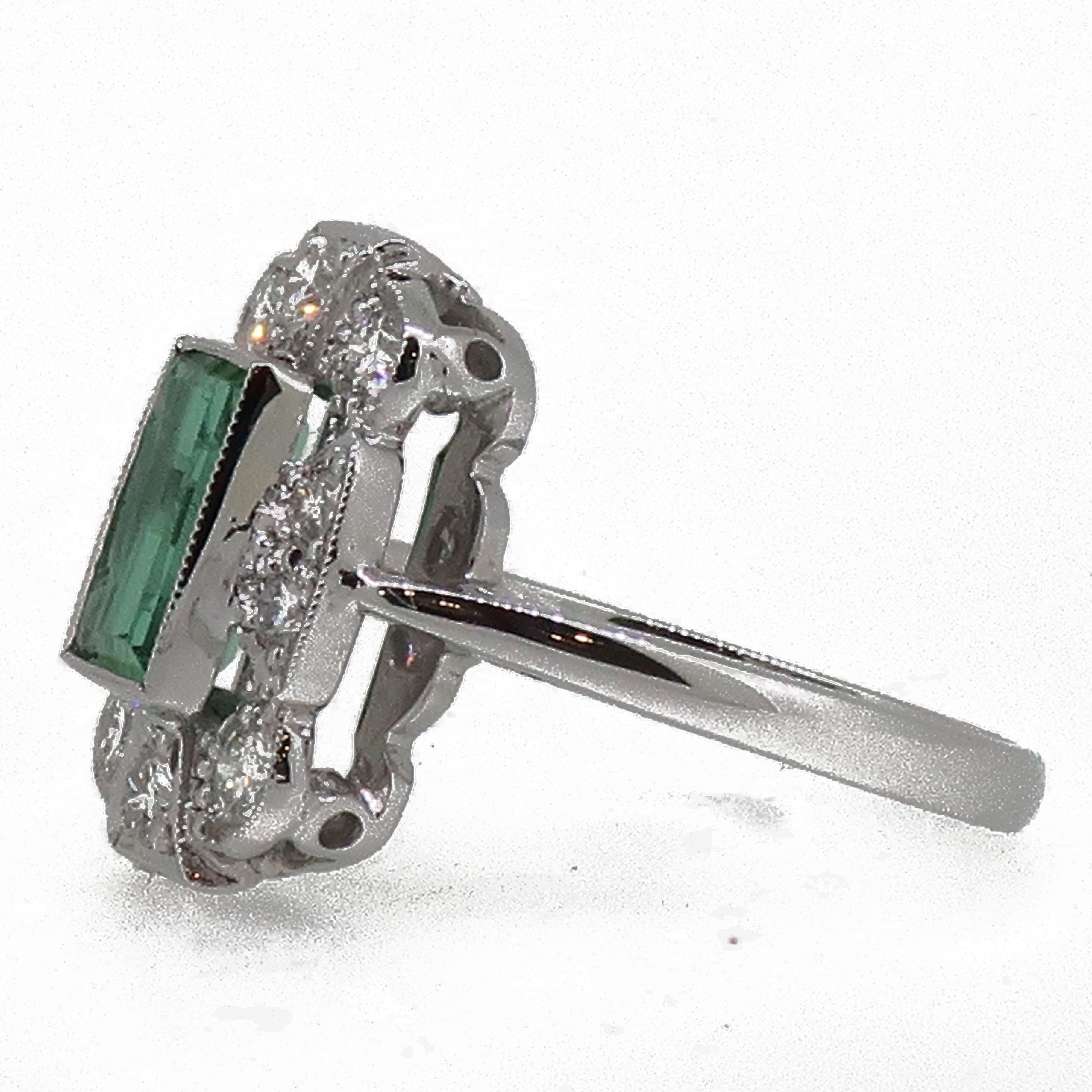 18 Karat Gold Baguette Cut Green Tourmaline & Diamond Art Deco Style Cluster Ring

A striking baguette cut green tourmaline set in a fine millegrain setting weighing 1.24ct, surrounded by ten round brilliant cut diamonds all set in a fine mill-grain