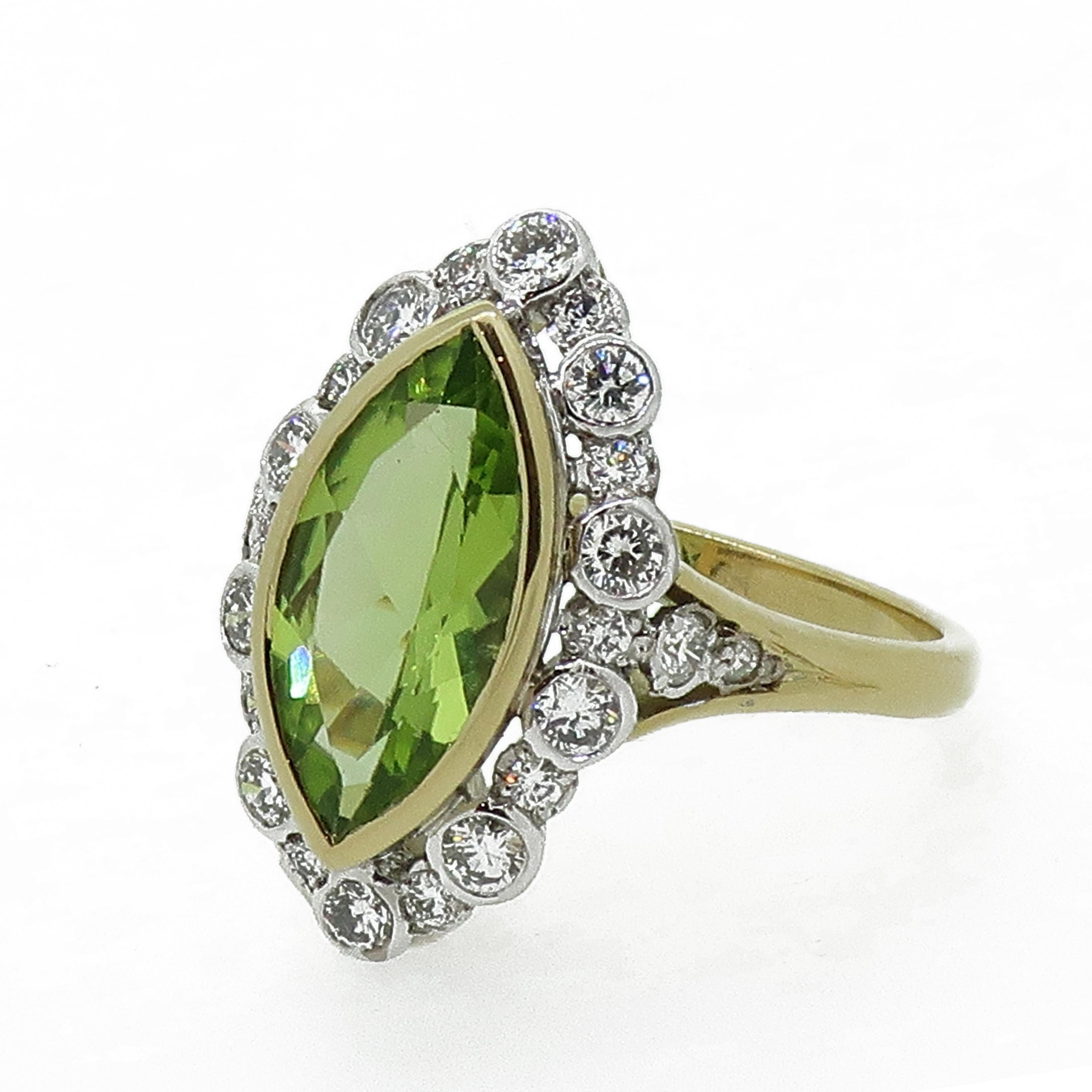 18Carat Gold Marquise Navvette Cut Peridot & Diamond Art Deco Style Cluster Ring.

A truly mesmerising marquise cut peridot set in a fine yellow gold bezel, surrounded by white brilliant cut diamonds all set individually in small rub over white gold