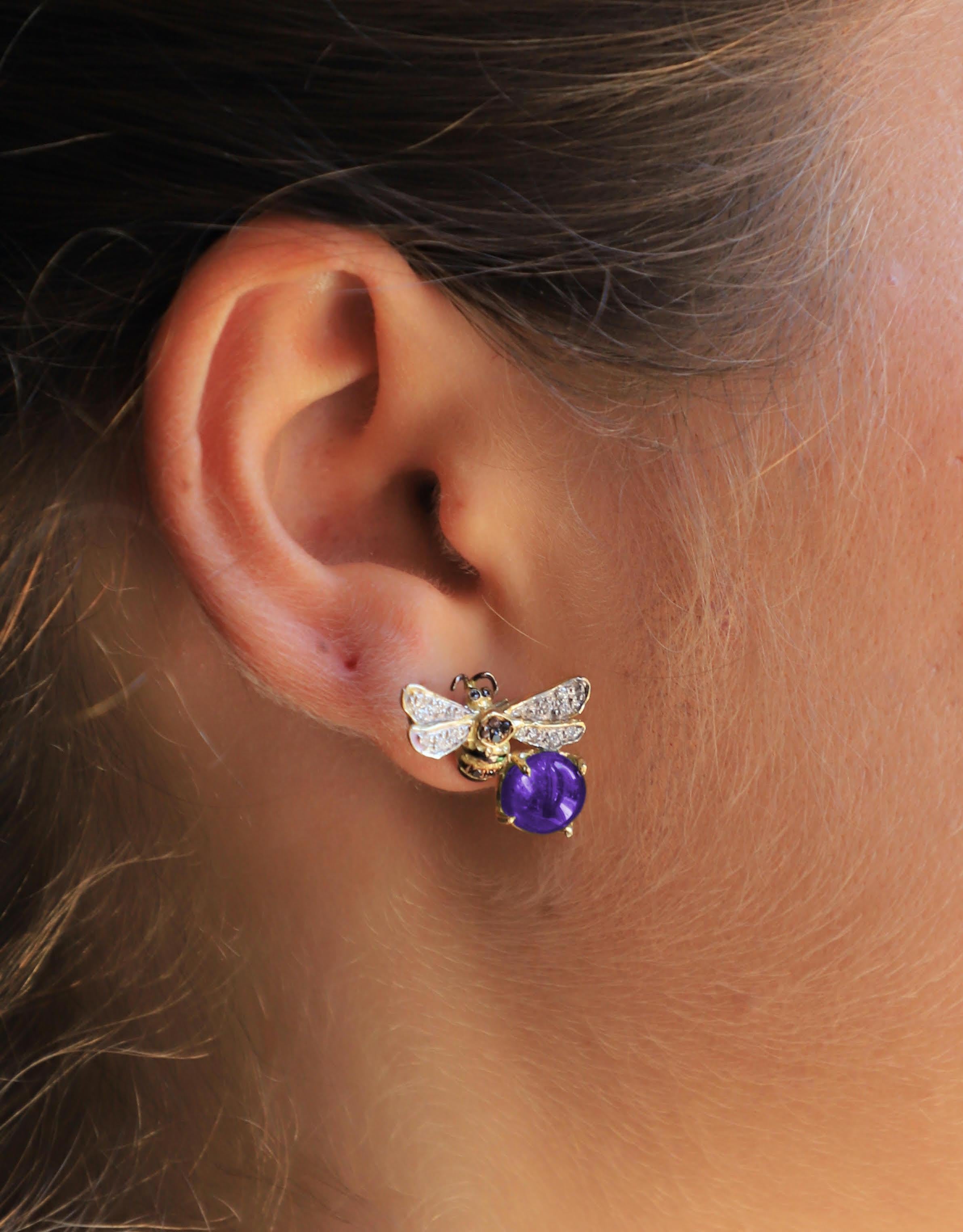 Rossella Ugolini Bees Collection, A beautiful pair of Bees Stud Earrings handcrafted in 18 Karats Yellow Gold and adorned with a deep violet amethyst, White and black Diamonds.  
This collection  celebrate a precious creature, essential for our