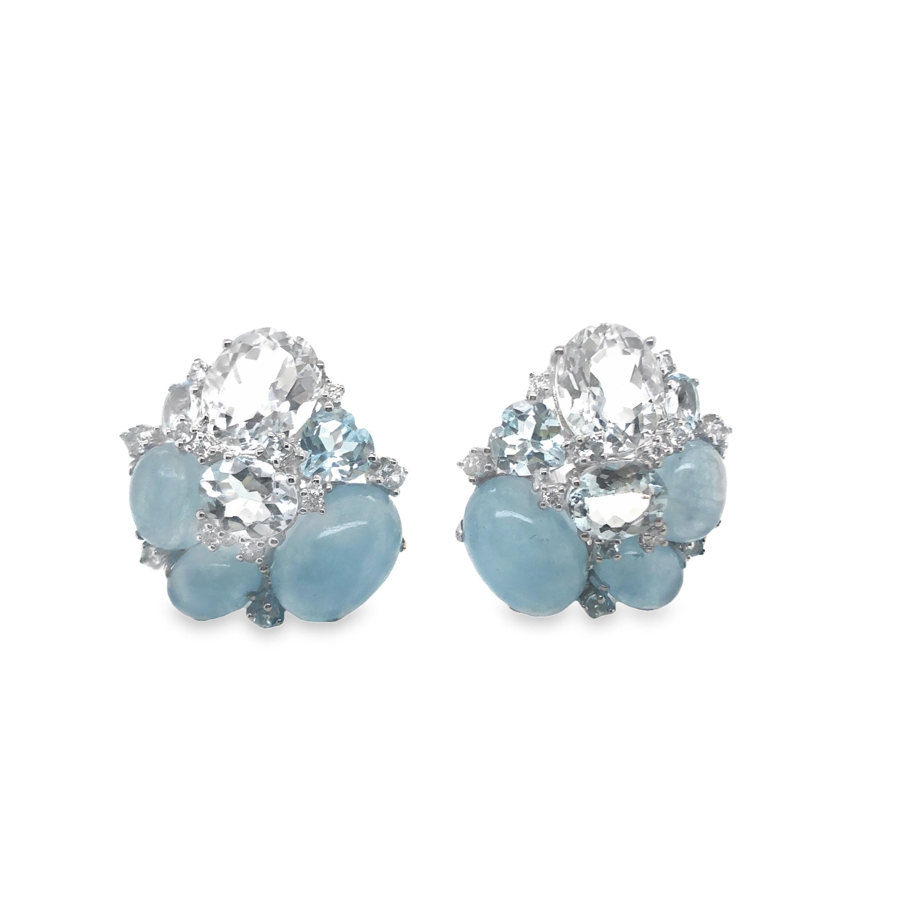 The 18KWG classic cluster ear clips feature a combination of oval cabochon and oval and heart-shaped faceted natural aquamarine stones accented with diamonds. This blend of gemstones creates a luxurious and eye-catching aesthetic that is perfect for