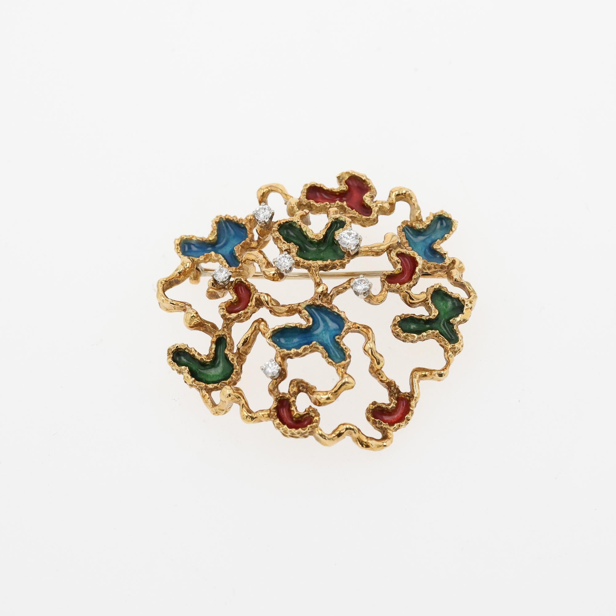 Vintage 18Y 1950's enamel brooch with 6 RBC=.35dwt approximate prong set.
Pin has free-form shape with enamel work in colors green, red, and blue with
textured finish. Standard pin closure. 13.2 dwt.