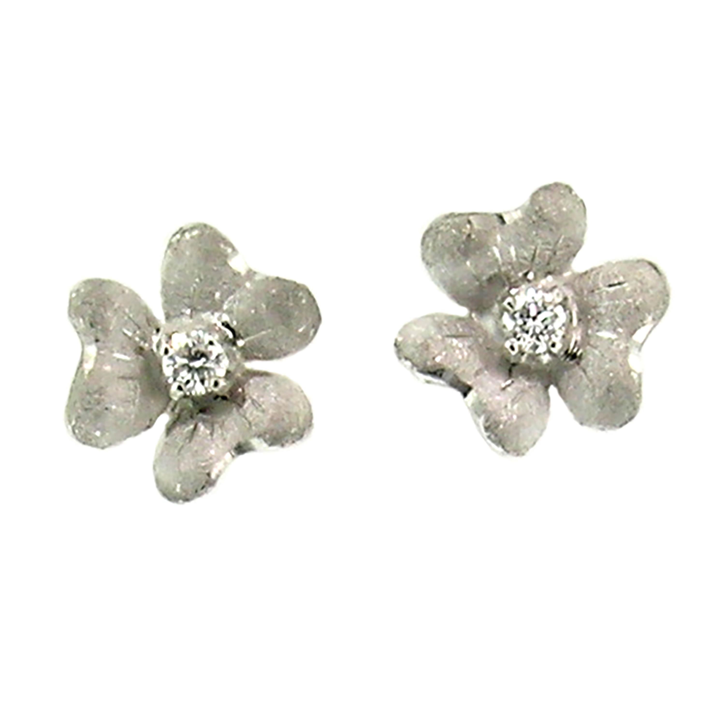 These sweet Floral stud earrings are hand engraved with a richly detailed Florentine finish. They are a sculpted, three-dimensional shape that sits beautifully on the ear, and each is set with a high quality diamond (with a total weight of 0.06ct).