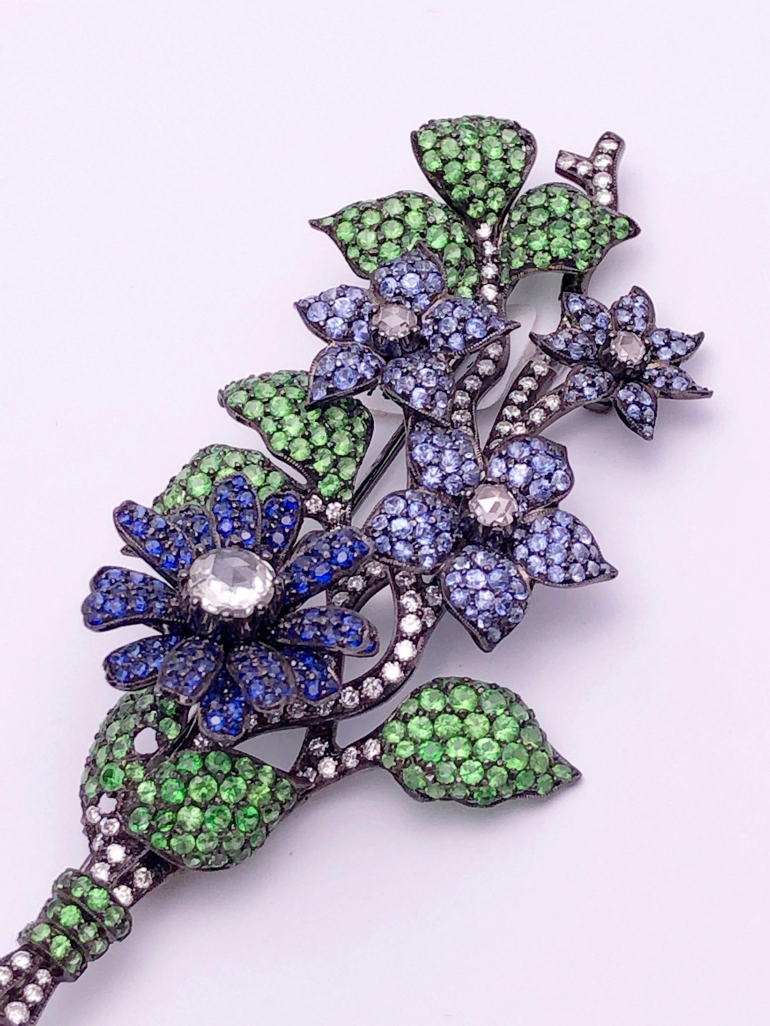 Round Cut 18Kt Blackened Gold Flower Brooch with Blue Sapphires, Tsavorites and Diamonds For Sale