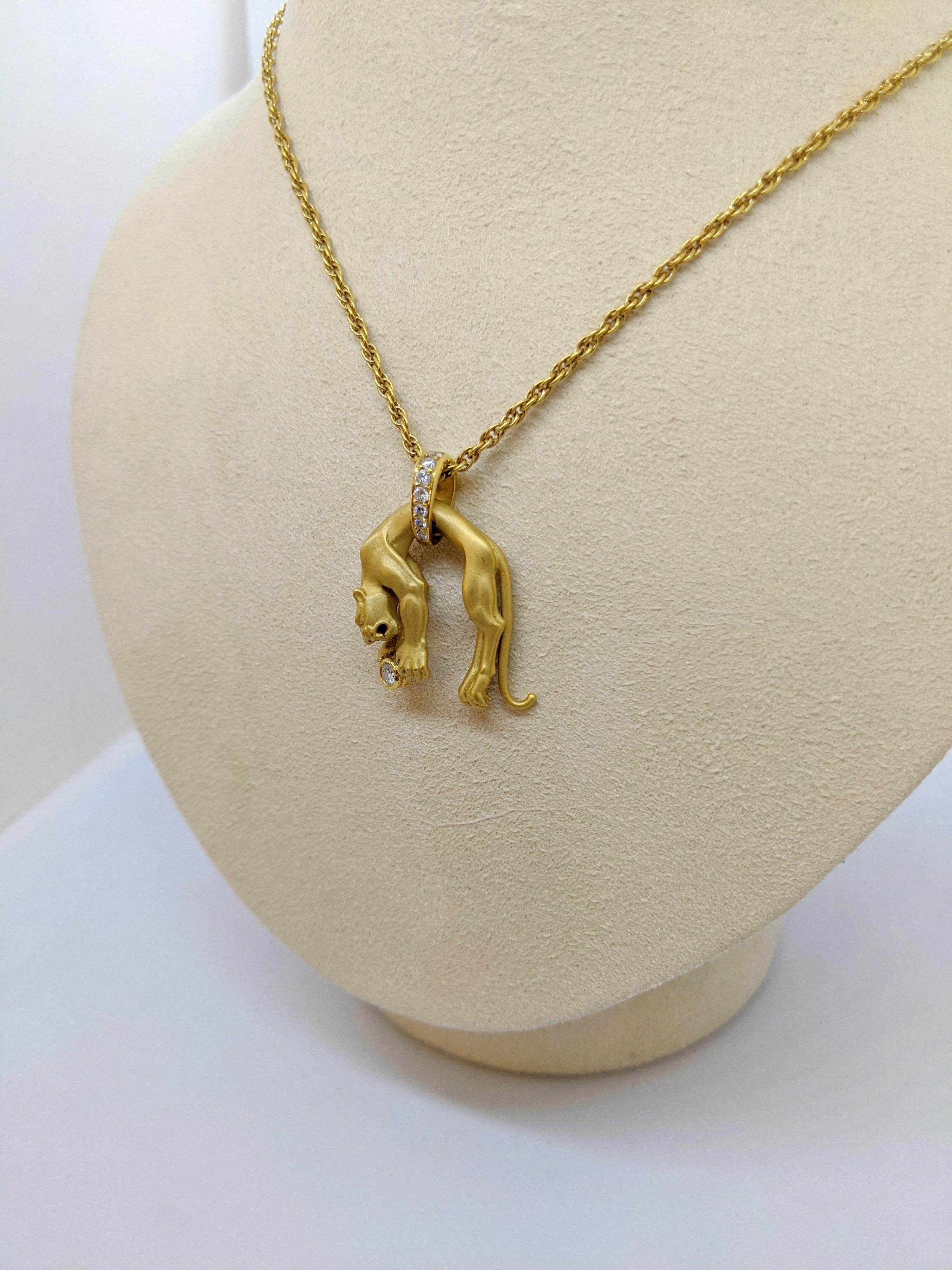 Expertly crafted in Spain by Carrera y Carrera, this elegant panther pendant lays beautifully on ones neck. Accented with diamonds, the highly detailed satin finished panther is holding a bezel set diamond and is hanging on an 18'' gold link chain.