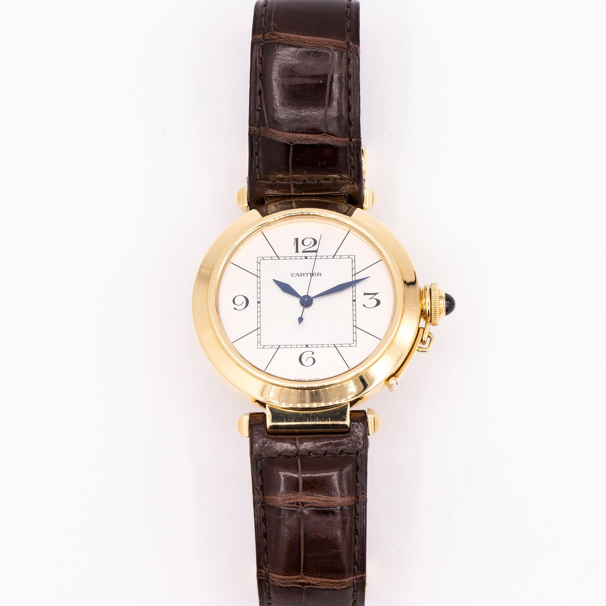 18kt Yellow Gold Cartier Pasha W3019551. Beautiful dress watch at 42mm in size adorned by a stunning silver dial. The hands are blue'd steel to add elegance. This timepiece is fully automatic and is set on a brown leather strap. This pasha is made