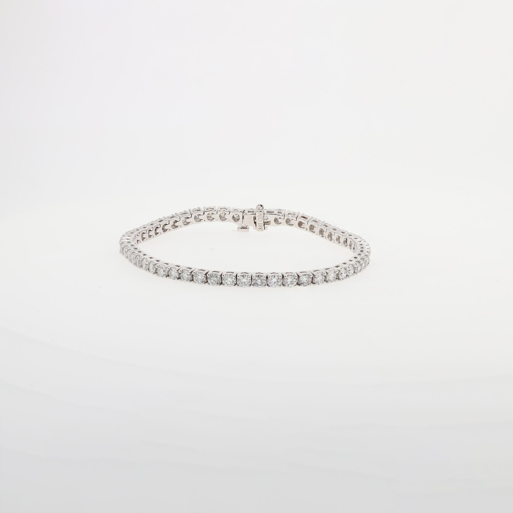 Vintage 18 karat white gold Diamond line bracelet with 53 round brilliant cut diamonds. The diamonds are G-H in color and SI1 in clarity. The diamonds are prong set with 4 prongs and an open wire mounting. 