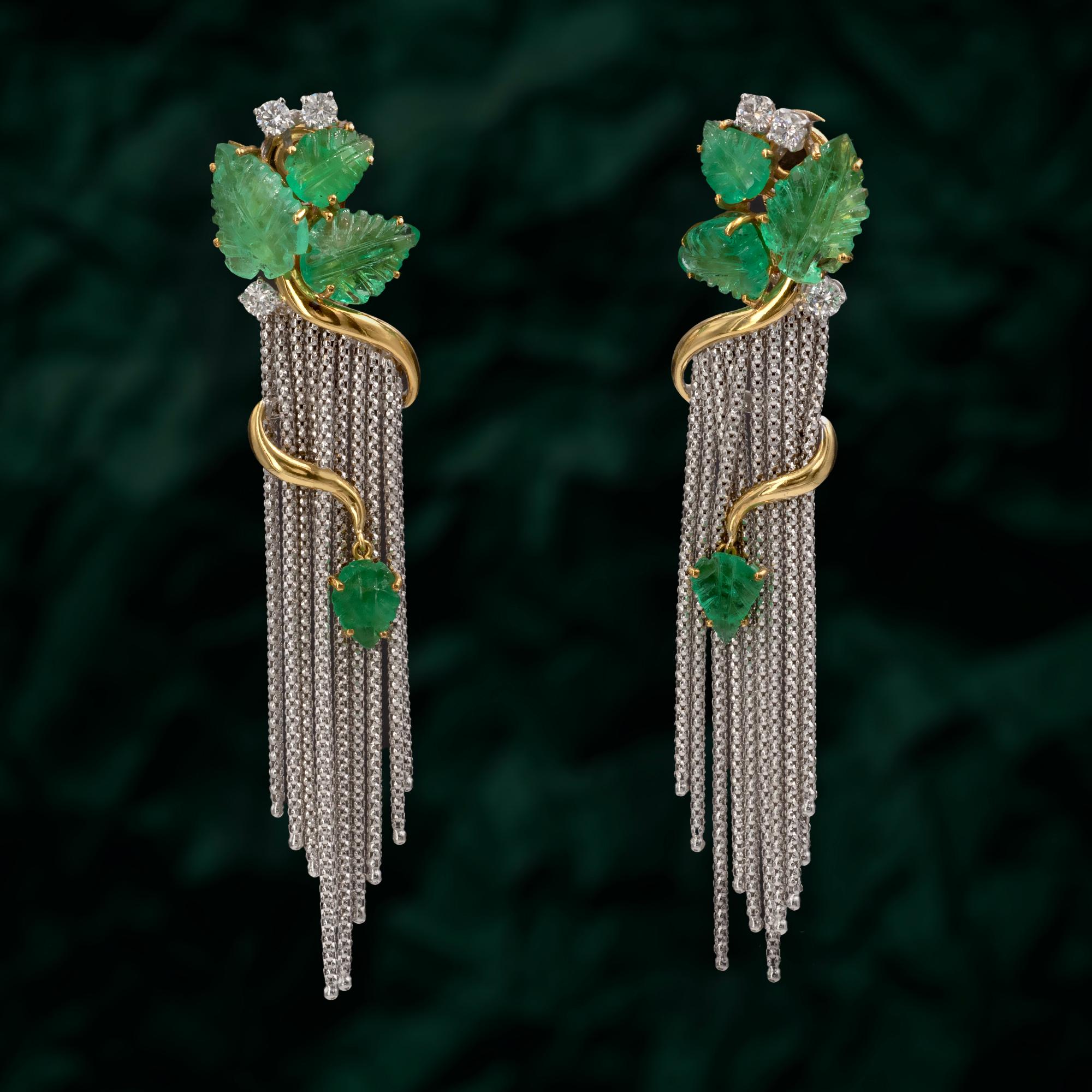 These exquisite clip-on earrings are a stunning blend of luxury and elegance, crafted with meticulous attention to detail. They feature vibrant, carved emerald leaves, totaling 10.91 carats, set in 18K yellow gold. The design is inspired by nature