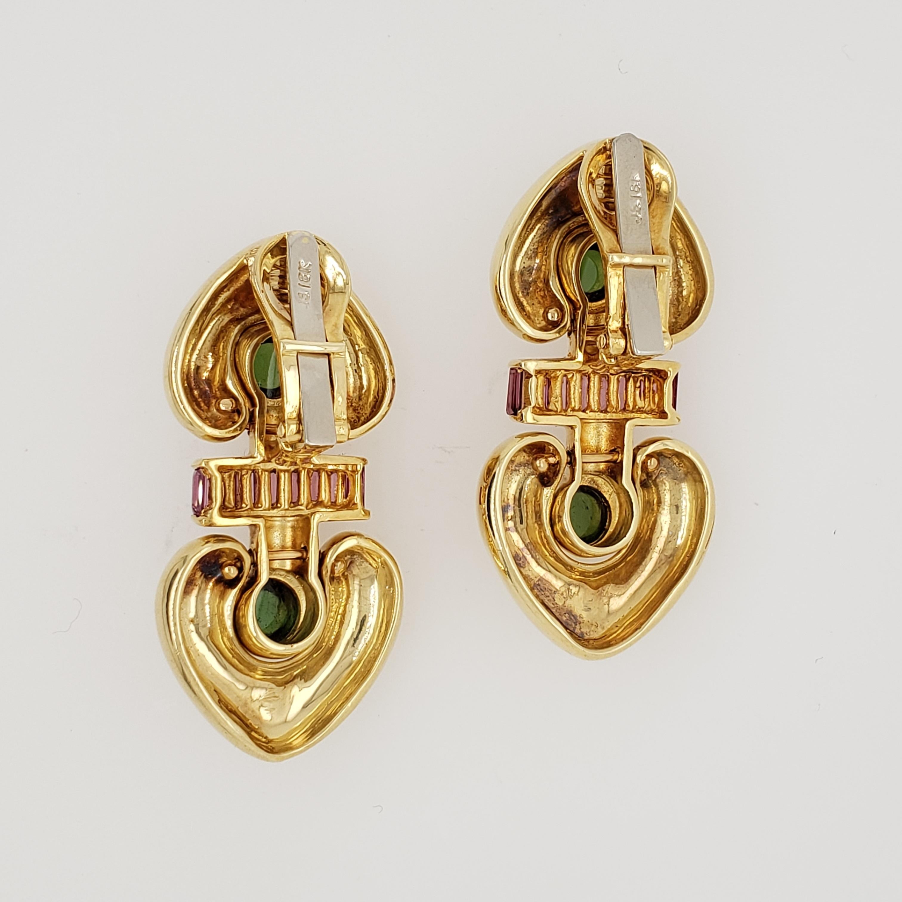 18kt yellow gold ear clips. Each set with 9 calibrated baguette pink tourmalines, 18 in total weighing aprx. 2.20 carats. There are 2 round cabochon green tourmalines, 4 in total weighing aprx. 1.50 carats. The earrings weigh 39 grams in total. Made