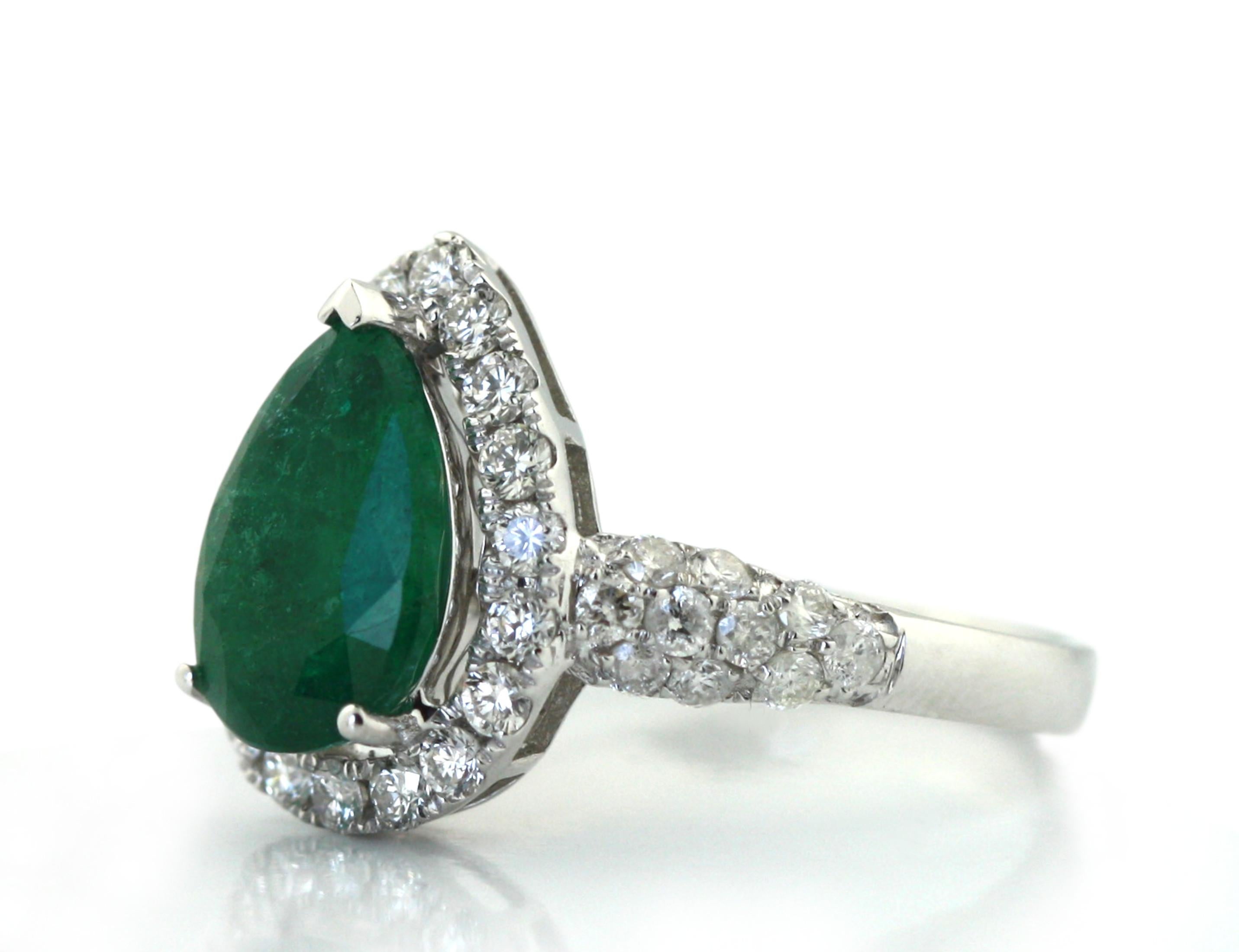 
18KT Emerald and Diamond Ring 
Set with a pear shaped, natural emerald 
Weighing approximately 2.20 carats 
within a surround of thirty-eight round, brilliant-cut diamonds
weighing approximately 0.83 carats 
gross weight approx. 4.10 grams 
size 7.