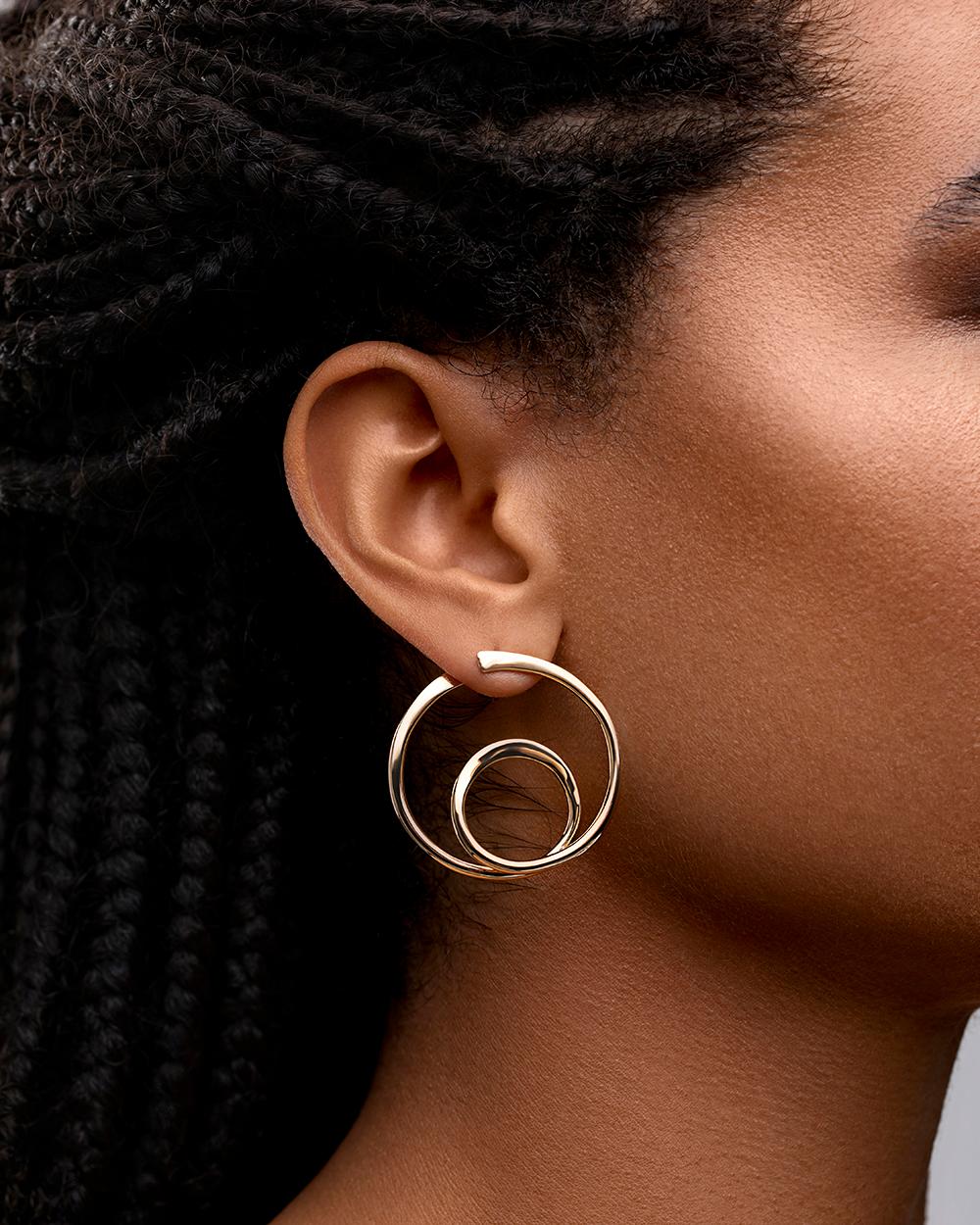 Designer: Art Smith

The Orbit hoops are a Legendary twist on the classic hoop, originally designed by Renowned Jeweler Art Smith, in Greenwich Village.

Handcrafted in NYC with 18kt certified Fairmined Ecological gold that is toxic chemical free,
