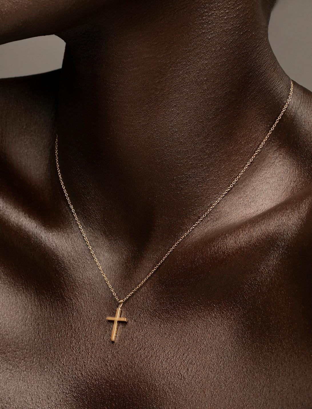 A sleek modern Cross necklace.

Handcrafted in NYC with 18kt certified Fairmined Ecological gold that is toxic chemical free, sustainable, ethical and clean. Chain is 16