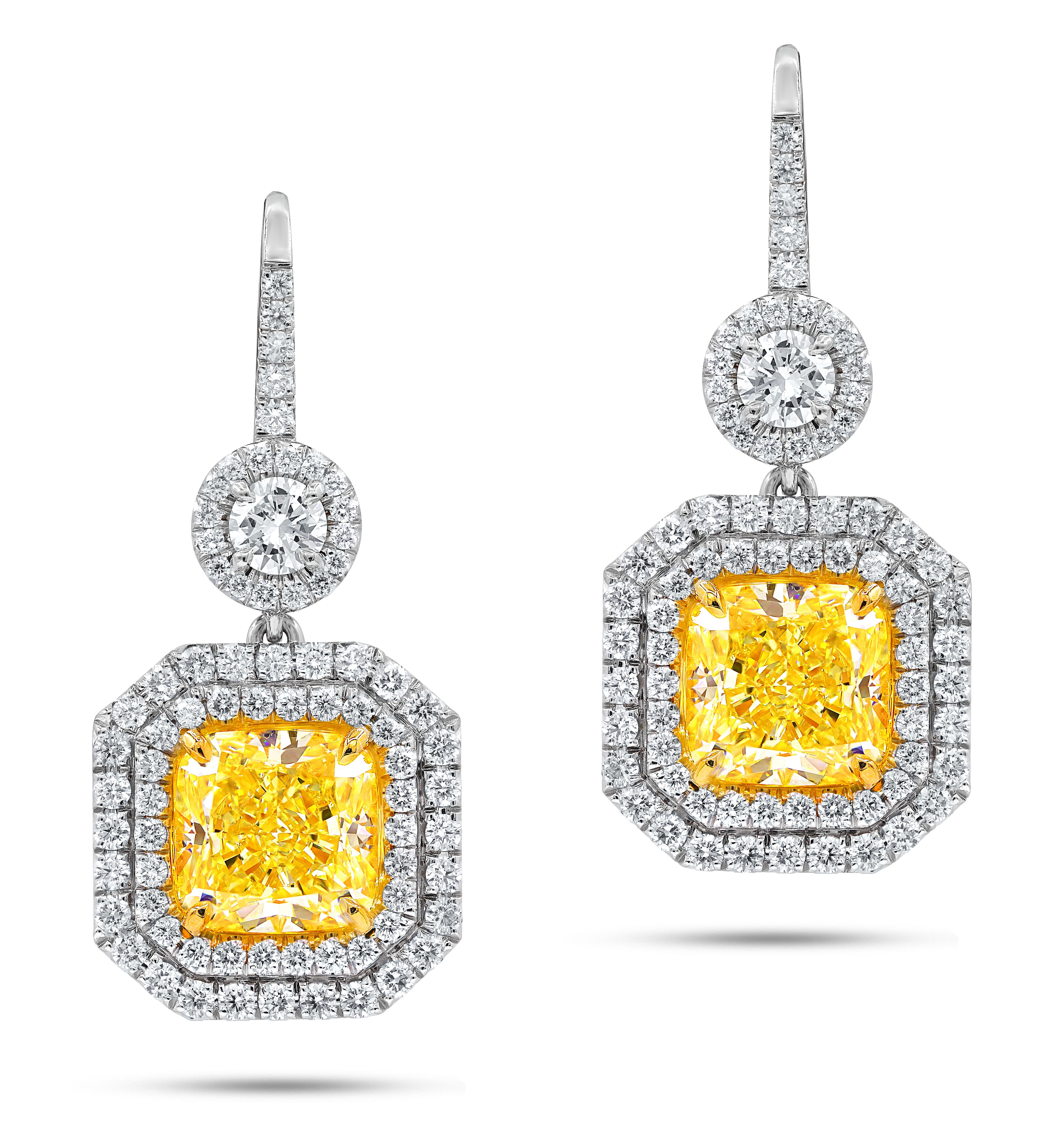 18kt fancy light yellow diamond earring set in a double halo setting, features gia certified yellow diamonds, 2.61ct vs1(rad1038) and 3.02ct vs2(radc1040) of fancy light yellow cushion cut diamonds and 1.75 carats of white diamonds around f-g/vs
