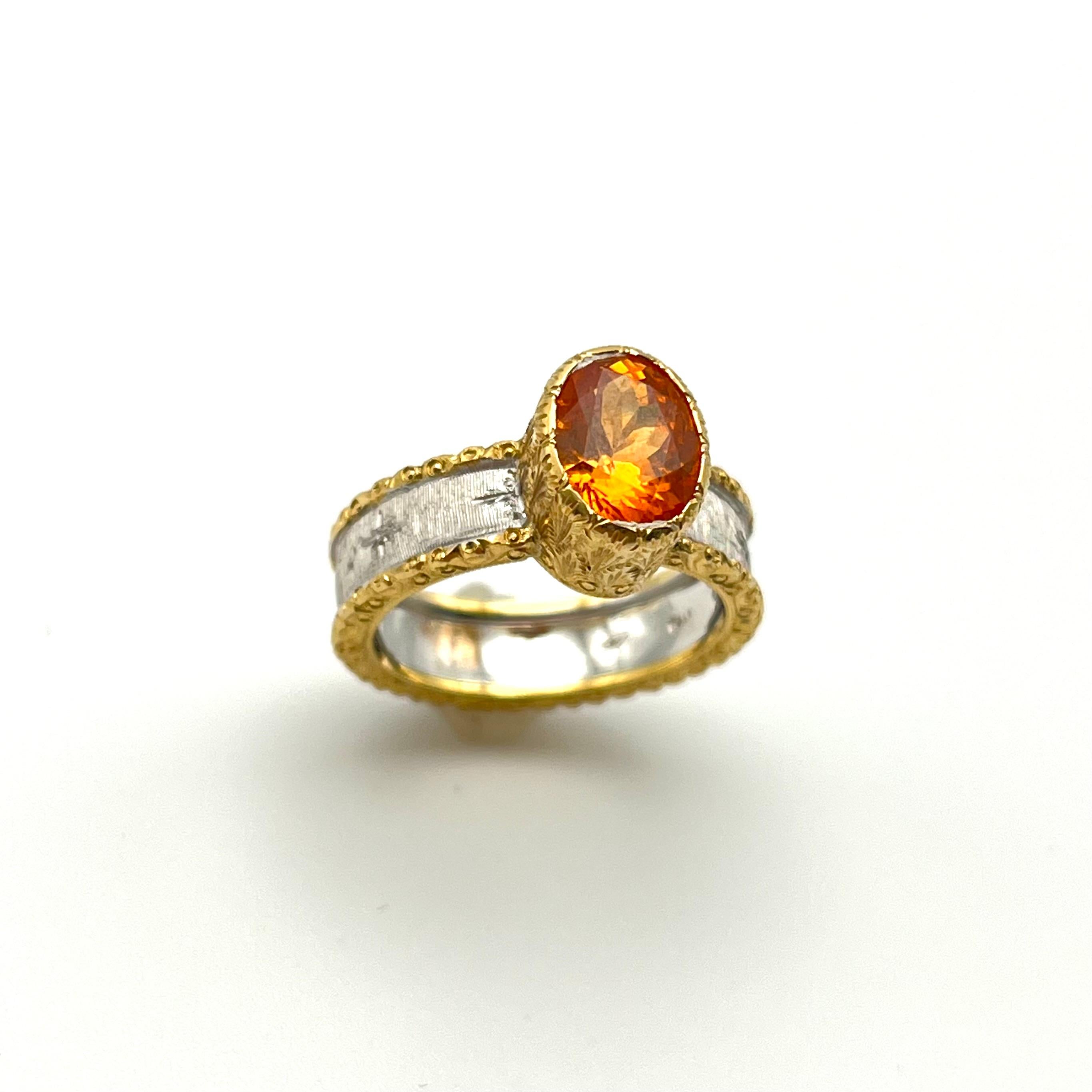 This cocktail ring is warm and happy. It was handmade by a family jeweler outside of Florence, Italy with a specially selected mandarin garnet. It is crafted out of solid 18-karat yellow and white gold with each silk line being carved by hand.