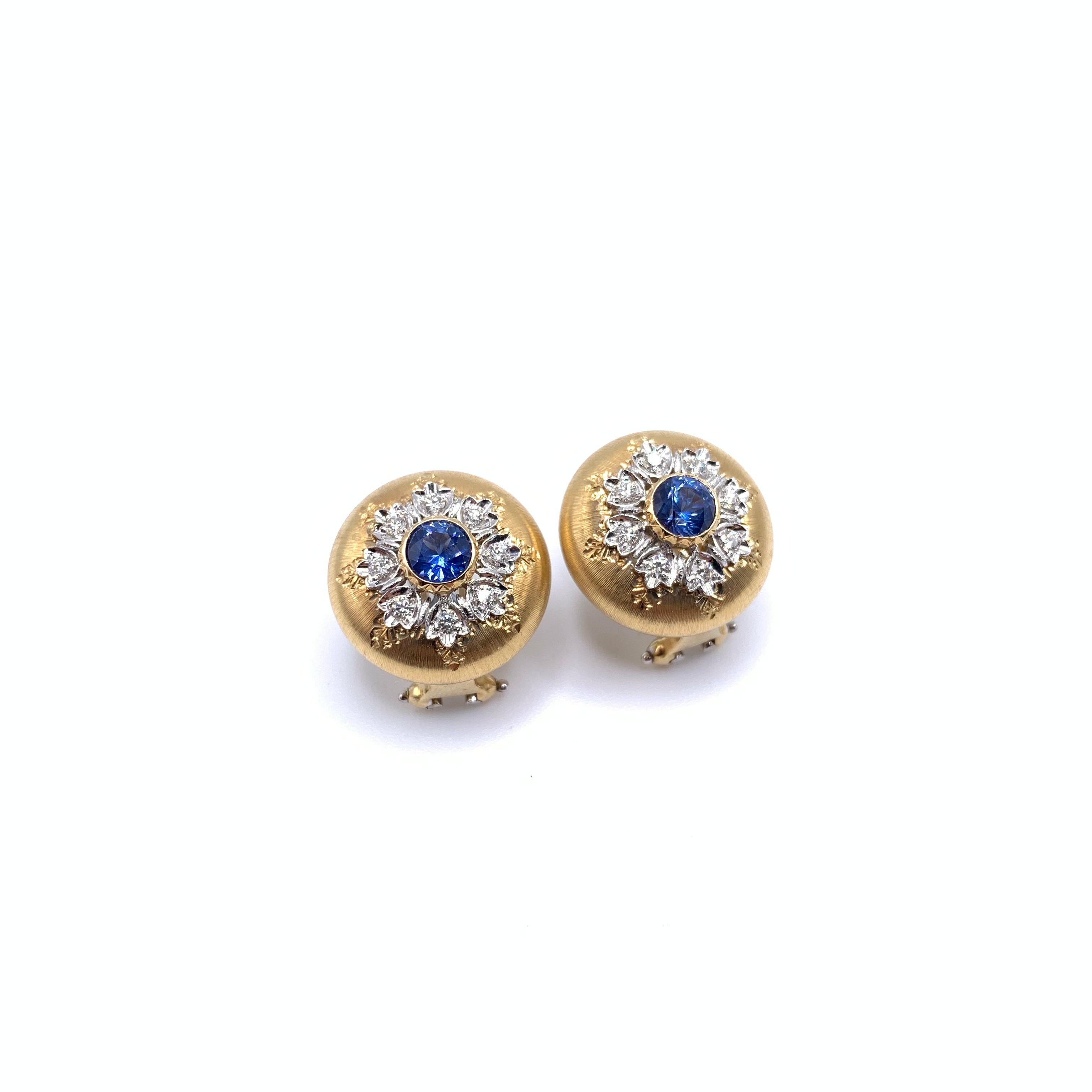 These beautiful sapphire earrings were handmade by a family jeweler outside of Florence, Italy. The pair is set in solid, 18-karat yellow gold with white gold embellishments within the mandala. Delicate lines have been individually carved into each