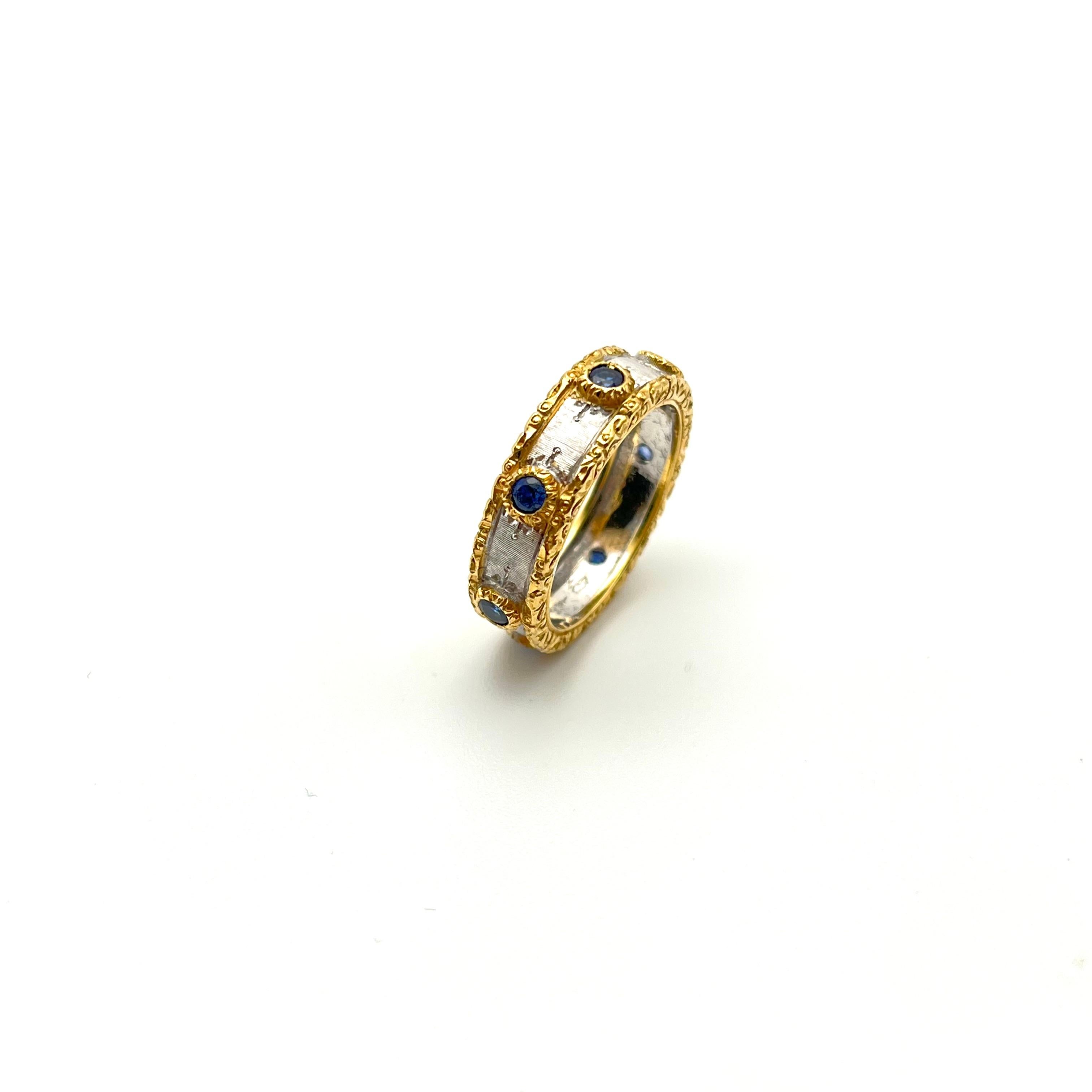 This regal eternity band was handcrafted by a family jeweler outside of Florence, Italy. It features delicate, Florentine engraving with each line scratched into the gold by hand to give it a rich silk effect. A solid, 18-karat white gold inlay is