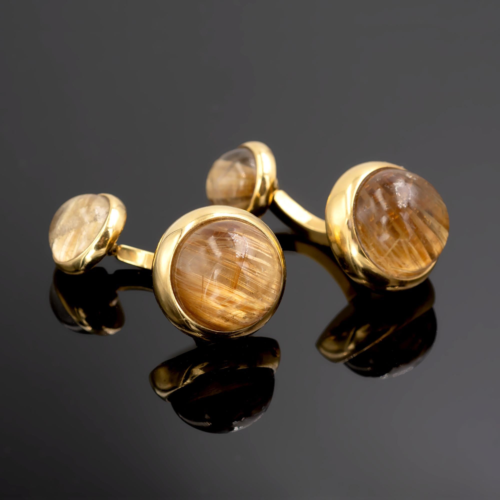 Elegant Cufflinks in 18 Karat Gold with round cabochon Rutilated Quartz bezel set on each end.
The modern design is pure and well-executed. The Cufflinks are very well-made and hefty.
Measures: 
Large side: 16.7 mm, Small side: 11.3 mm
Weight: 23.7