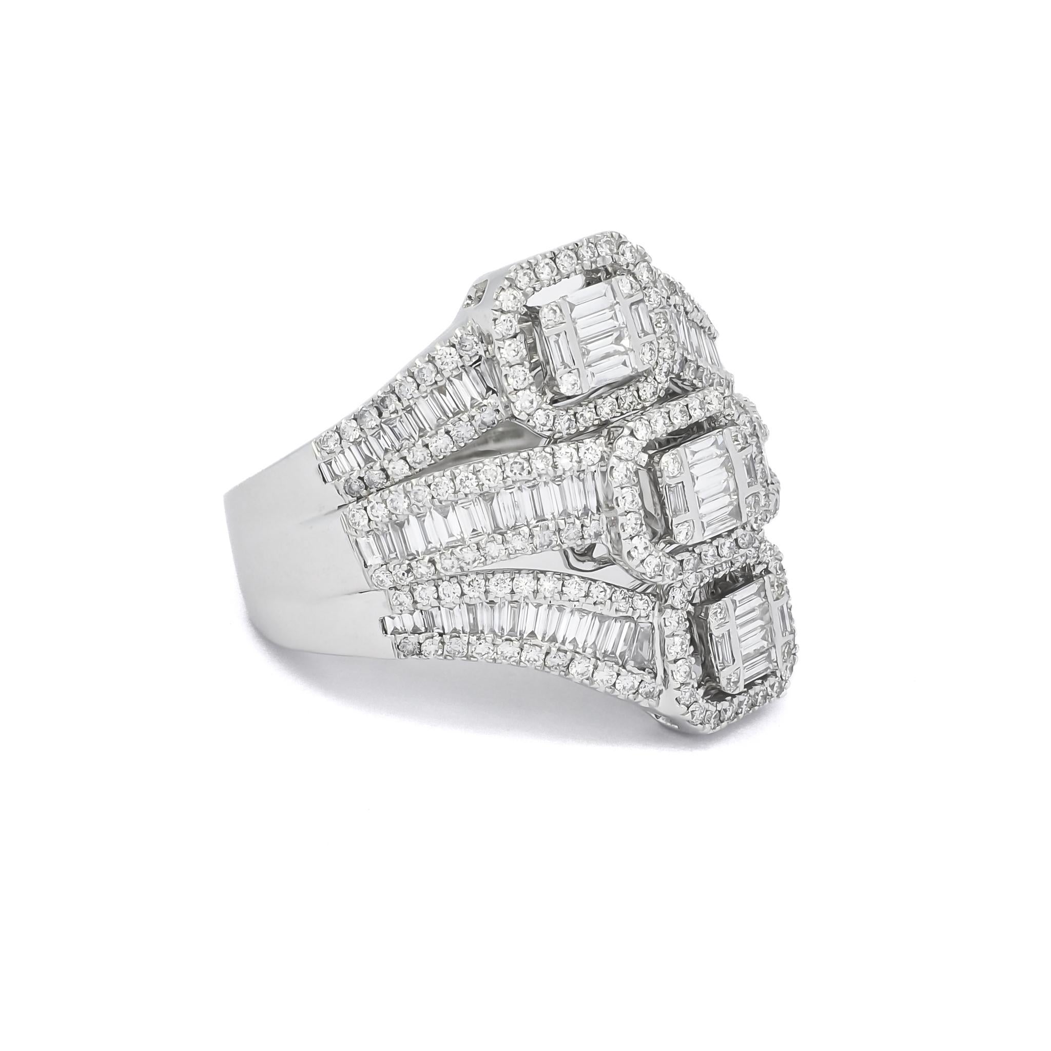 A trio of white gold baguette clusters are combined with a halo, highlighting on the side with accented baguette diamond shank. 
The Three Diamond Cluster Ring is a stunning statement piece, perfect for adding a touch of luxury and sophistication to