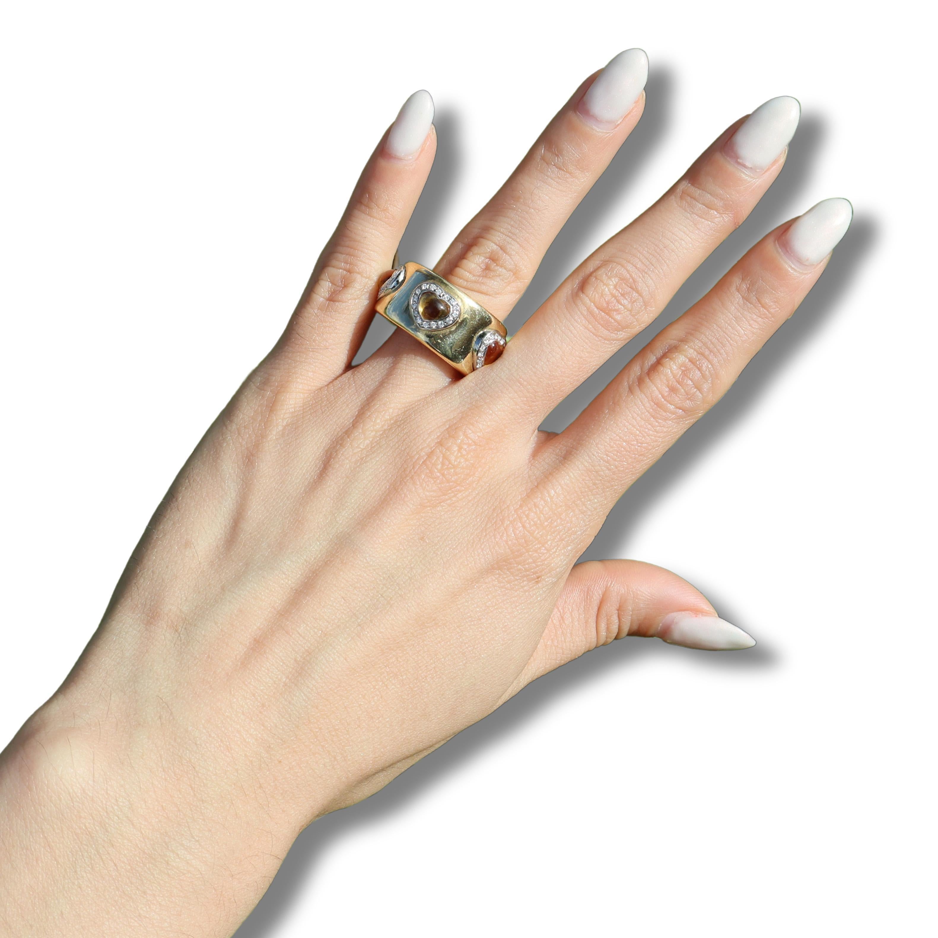 Elevate your jewelry collection with this stunning 18kt yellow and white gold band ring, a true embodiment of elegance and charm. This exquisite piece features five natural heart-shaped citrines, totaling approximately 3.60 carats. The vibrant