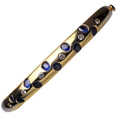 18kt Gold Bangle with 1.64ct. Oval Sapphires and .20ct. Round Brilliant Diamonds