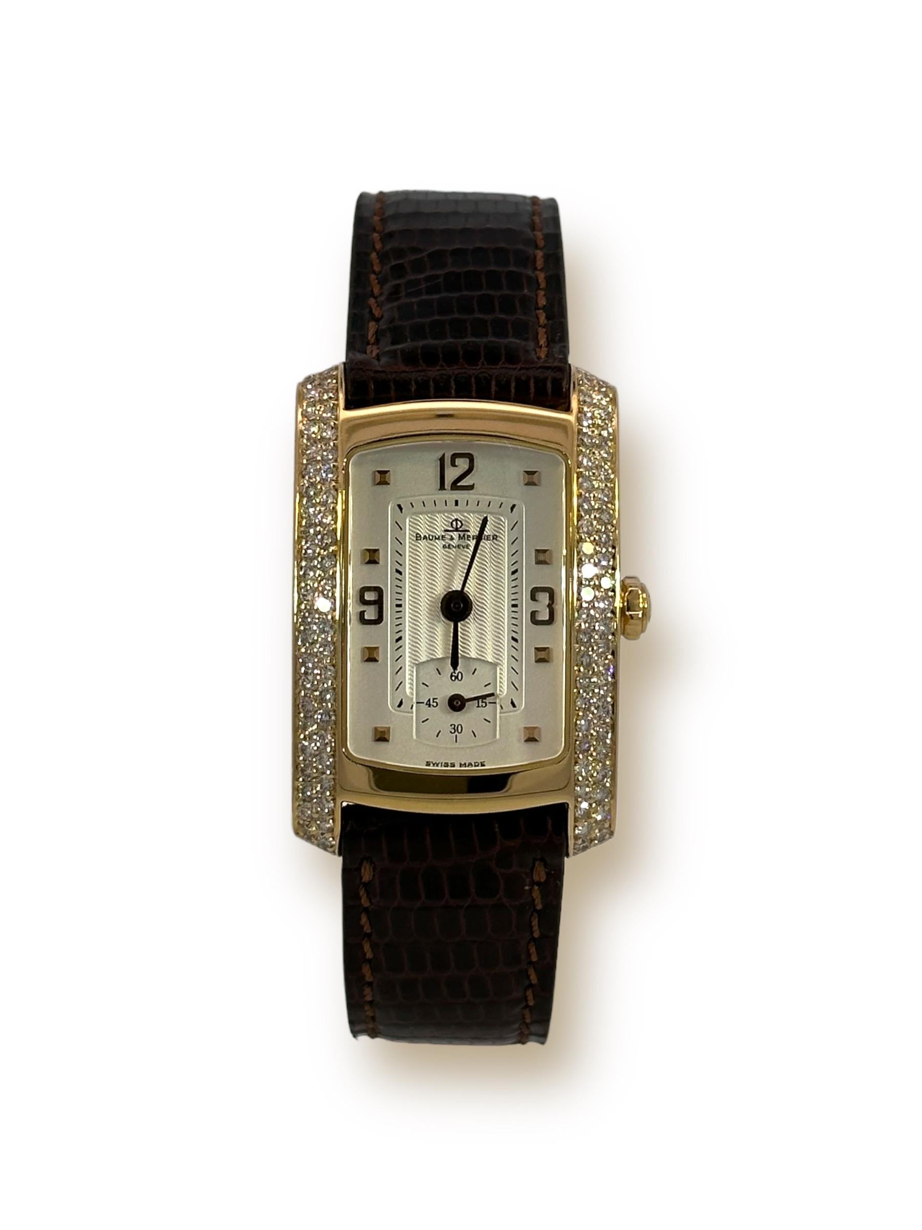 18kt Yellow Gold Baume & Mercier Hampton Diamonds Wrist Watch

Model ref number: MVO45229

Movement: Quartz

Functions: Hours, Minutes, Small second counter

Case: 18kt Yellow gold rectangle case 22mm x 27.5 mm x 6.8mm, Bezel set with