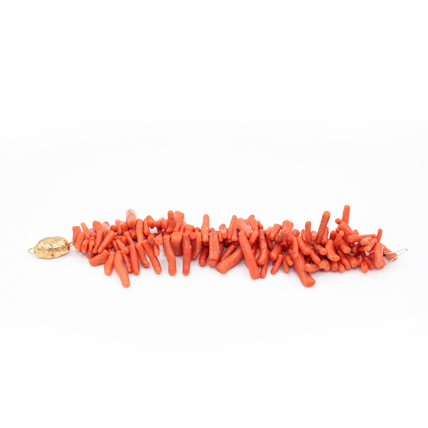 A very particular bracelet made up of coral elements and 18kt yellow gold clasp. 
Corallium rubrum
n. 3 strands 
18kt yellow gold clasp
Total lenght (including clasp) is cm 20