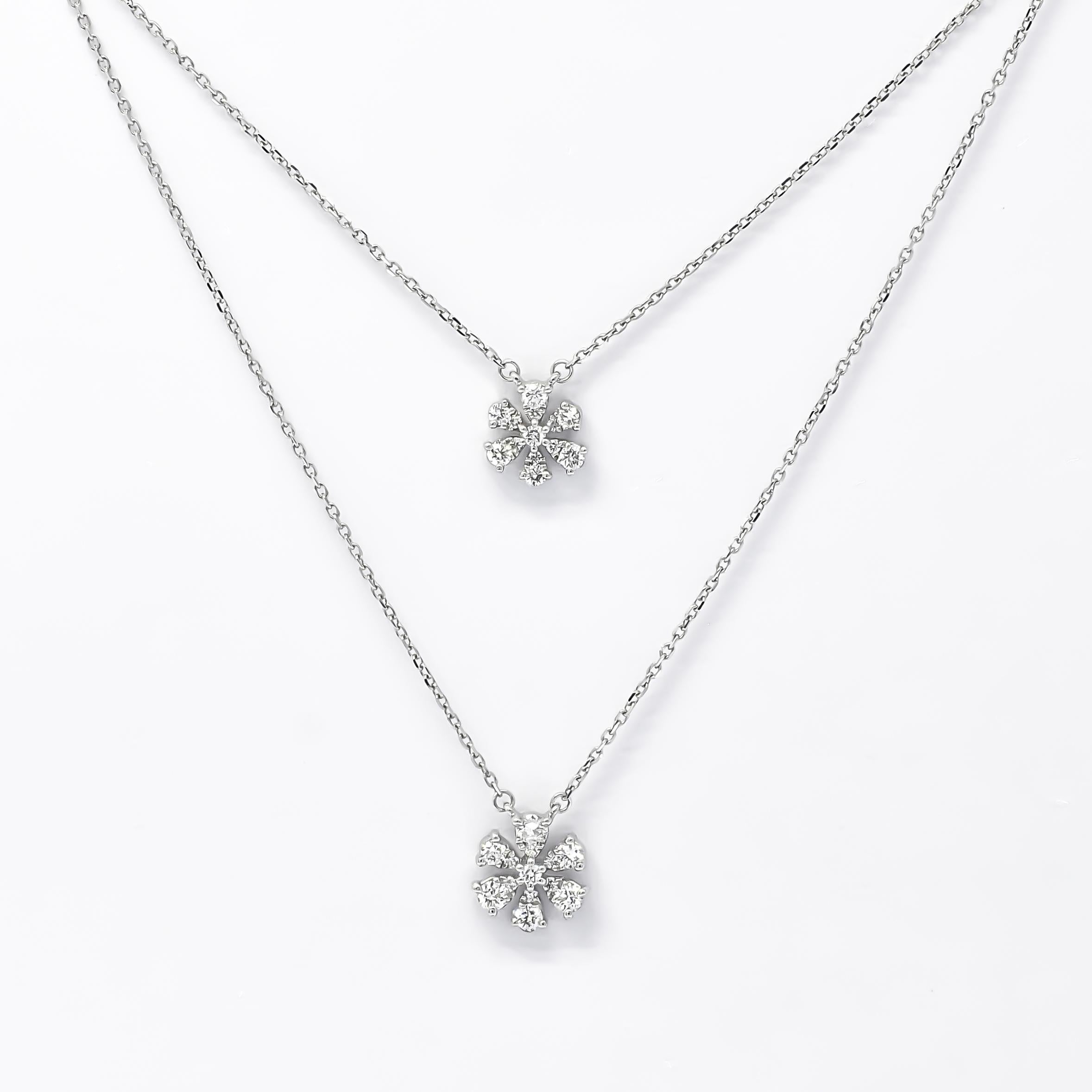 The necklace features a double-layer chain design that adds depth and dimension to its overall aesthetic. Each layer gracefully cascades along the neckline, creating a captivating visual effect that draws attention. The delicate chains are