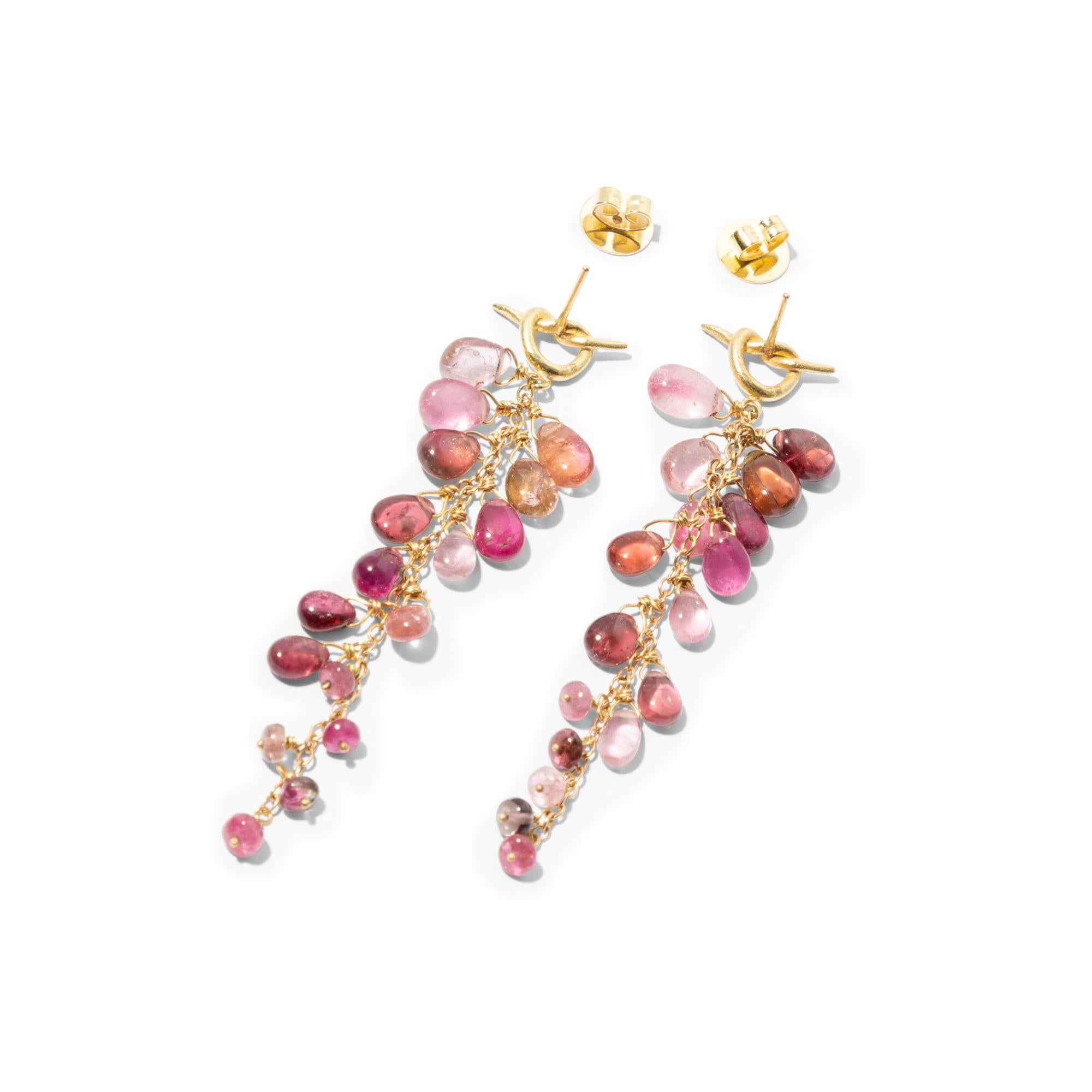 Gorgeous pair of 18k gold drop earrings with sumptuous, crystal clear pink tourmaline beads cascading down like a bunch of pink grapes creating lots of movement. 
A quirky 