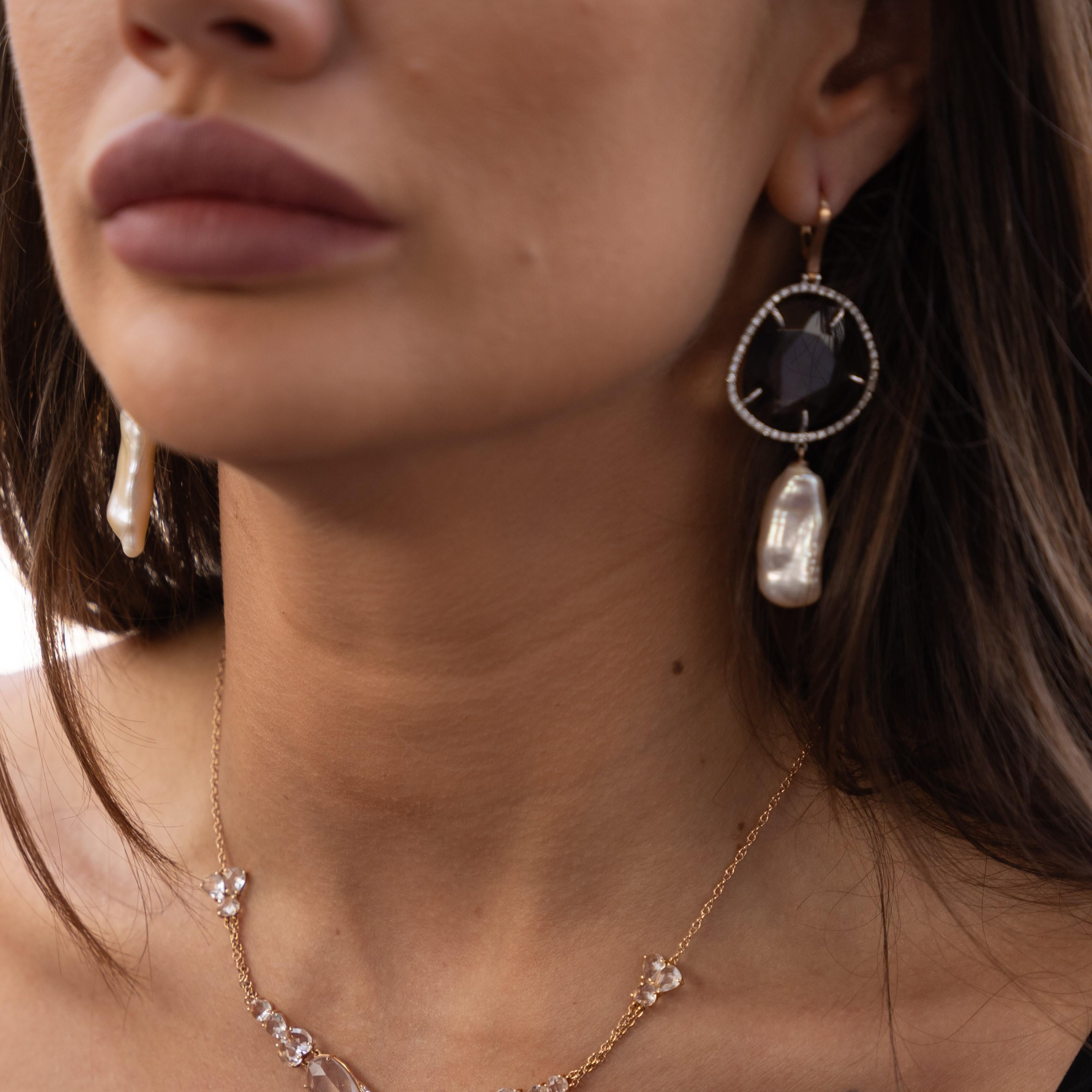 These earrings are crafted by Italian artisans in 18KT gold and feature a stunning combination of smoky quartz, diamonds, and keshi pearls. The smoky quartz gemstones add a touch of warmth and sophistication to the design. The diamonds, known for