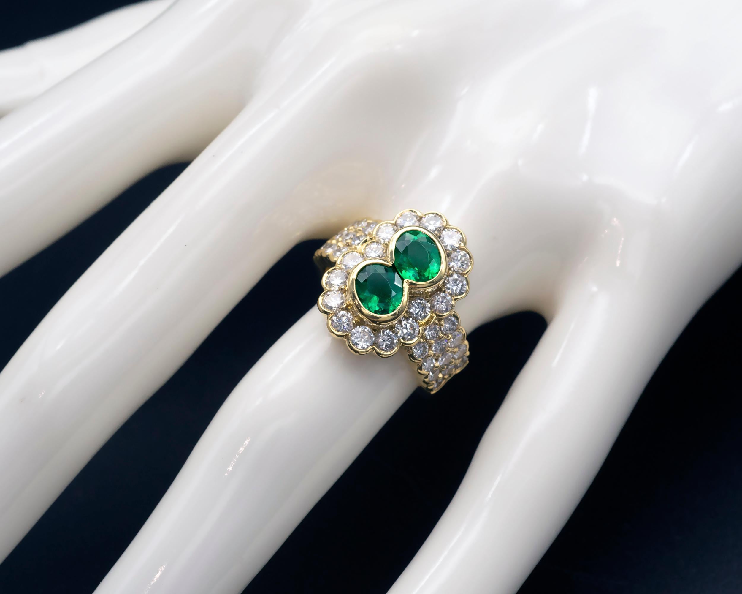 Contemporary 2 Oval Emeralds and Diamond 18-Karat Gold Halo Ring For Sale