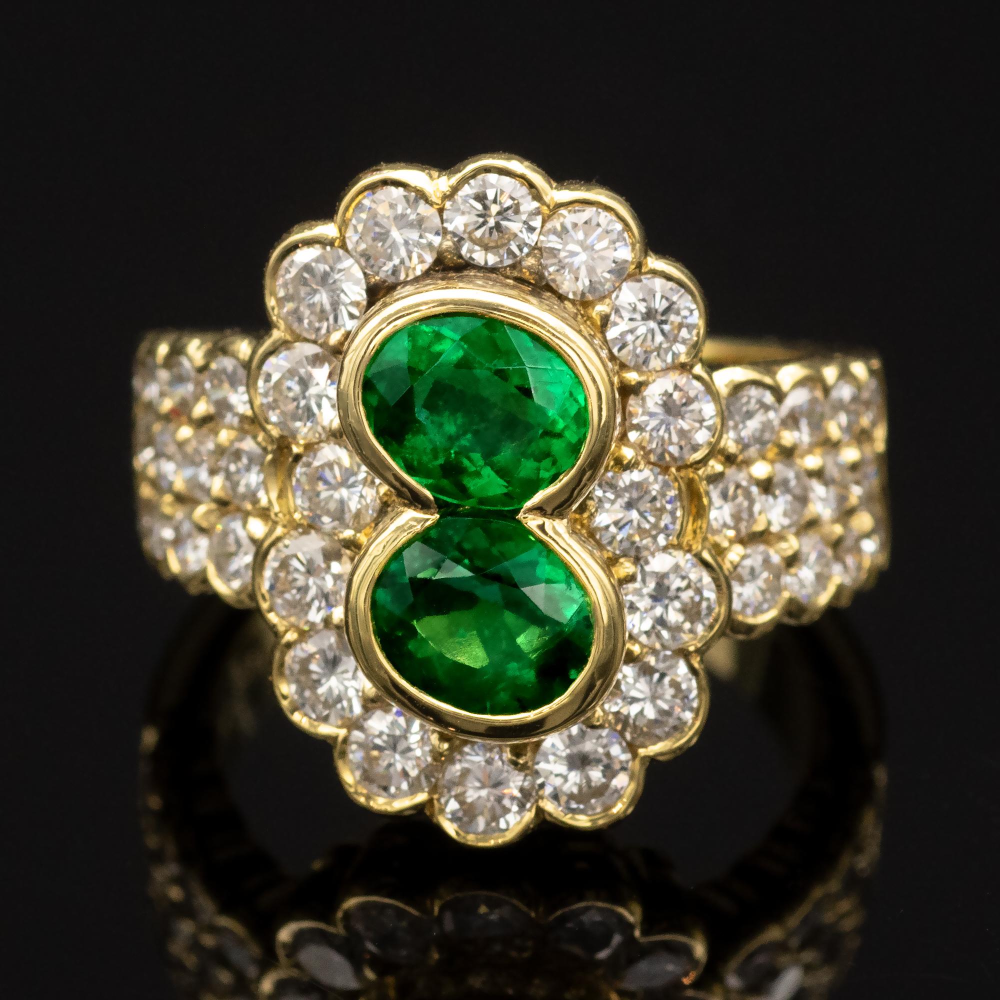 Oval Cut 2 Oval Emeralds and Diamond 18-Karat Gold Halo Ring For Sale