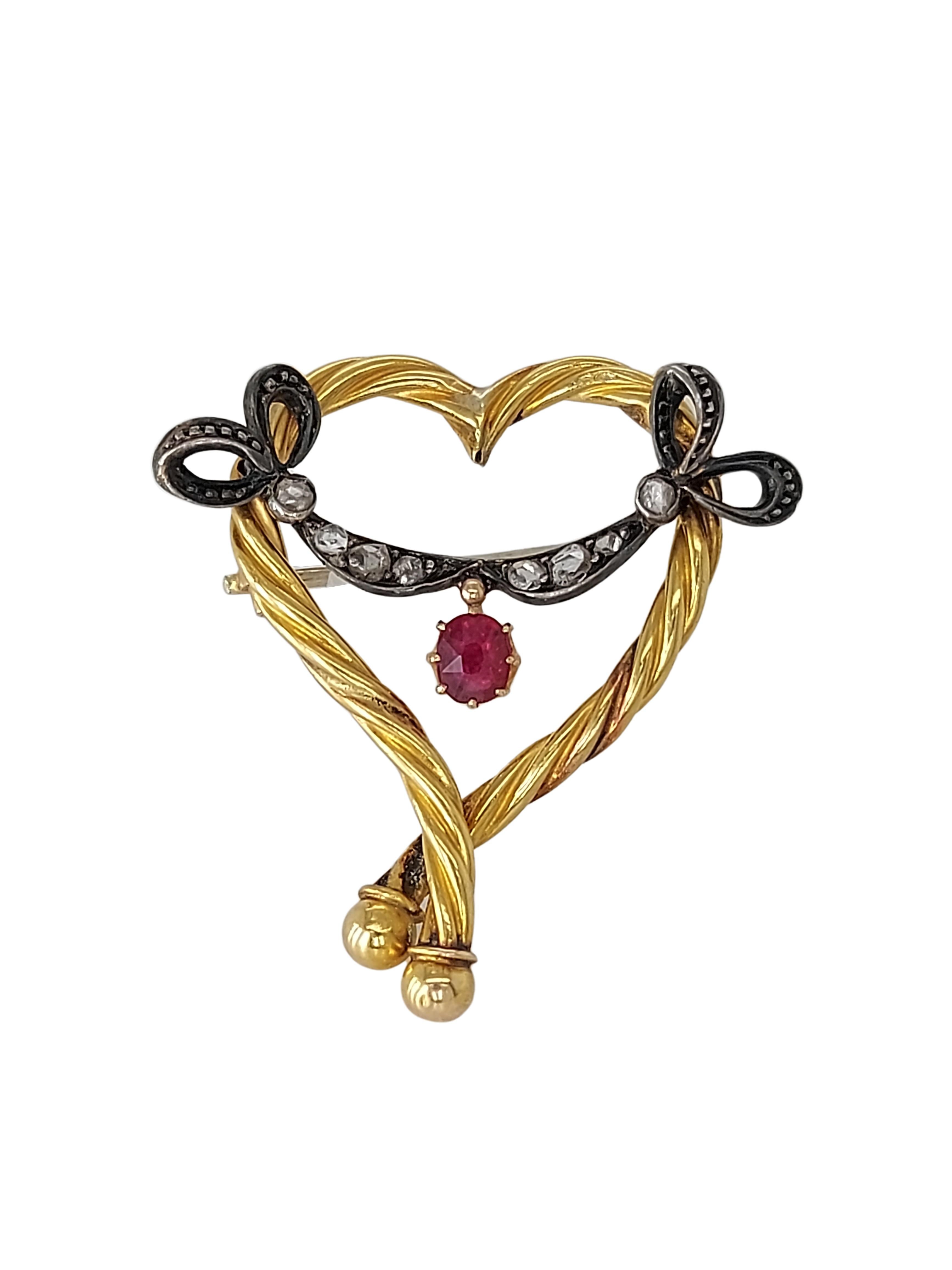 Lovely heart shaped 18kt Yellow Gold brooch with dangling natural Ruby & old cut diamonds set in Gold & Silver

Diamonds: 8 old cut diamonds set in silver

Ruby: Natural ruby, oval shape 3 mm x 4 mm

Material: 18kt Yellow gold and silver

Total
