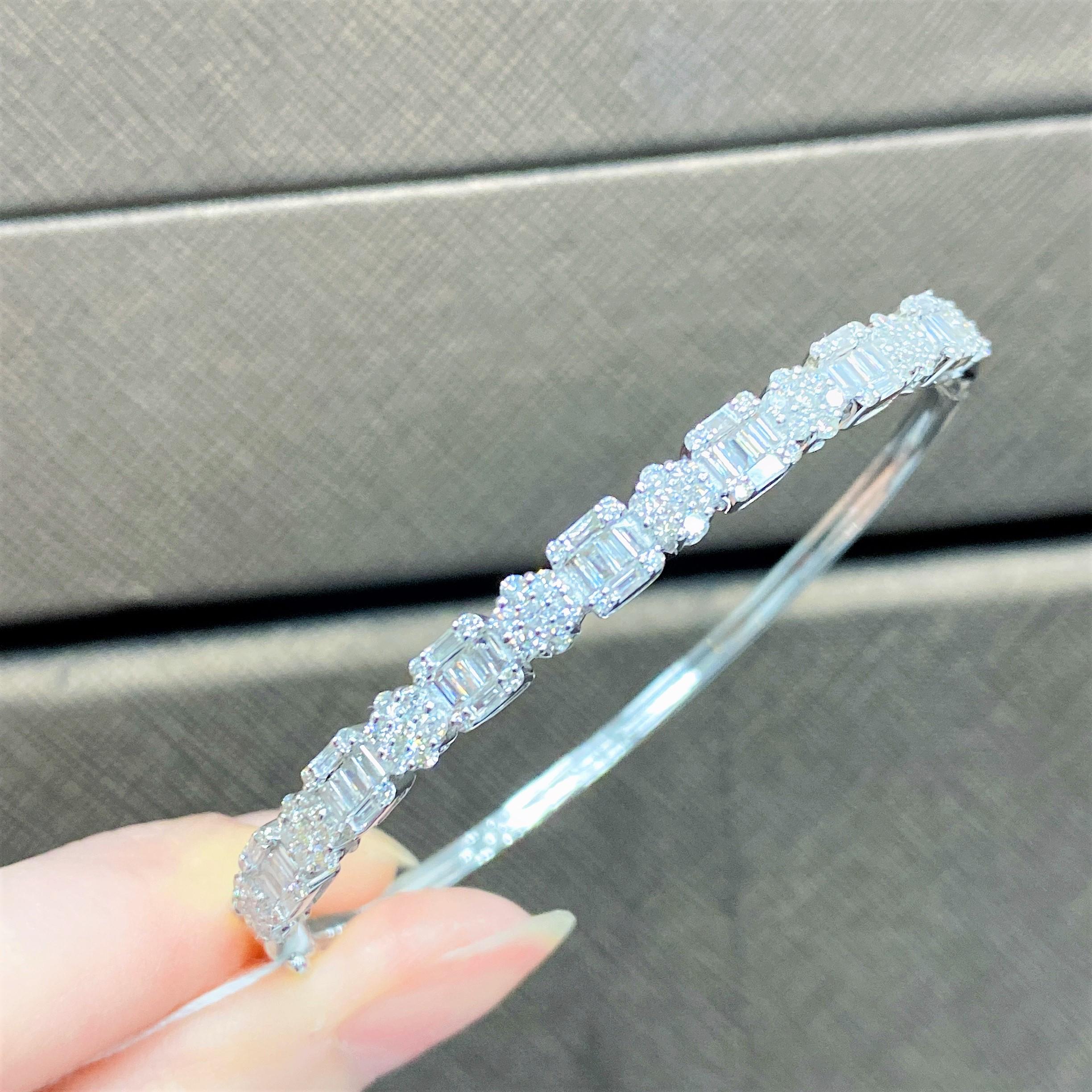 The Following Item we are offering is this Beautiful Rare Important 18KT White Gold Glittering Diamond Bangle Bracelet. Bracelet is comprised with Approx 1.50CTS of Magnificent Rare Gorgeous Fancy Trillion Baguette Cut Diamonds with Round Glittering