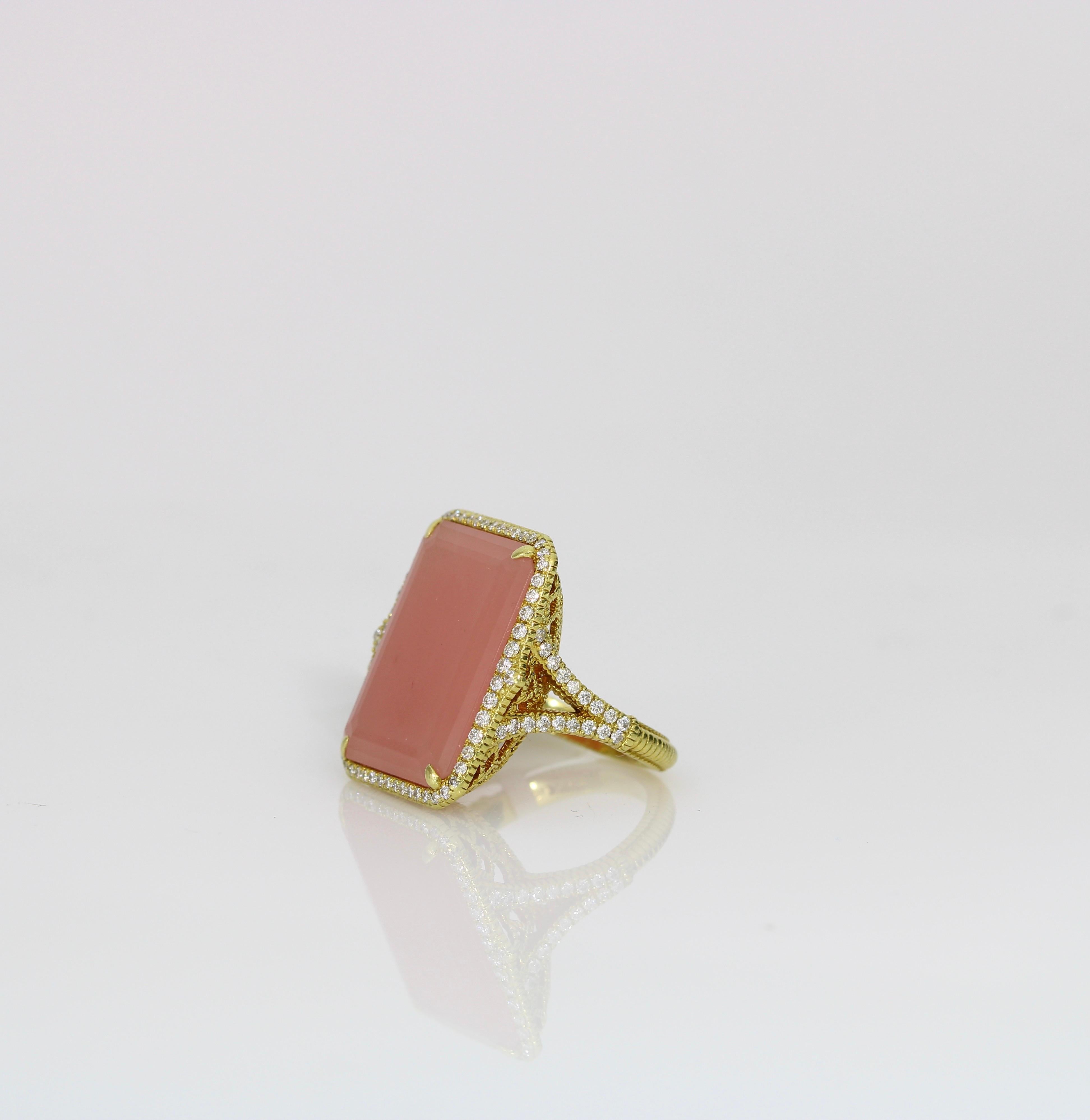 Enhance your jewelry collection with this exquisite 18k yellow gold ring from renowned designer Judith Ripka. Featuring an approximately 16-carat pink chalcedony stone, elegantly set alongside 1.10 carats of diamonds, this piece is a testament to