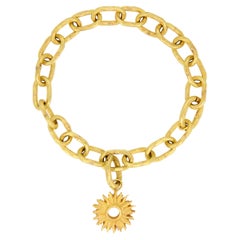 18kt Gold Link Charm Bracelet with a Sunburst Charm