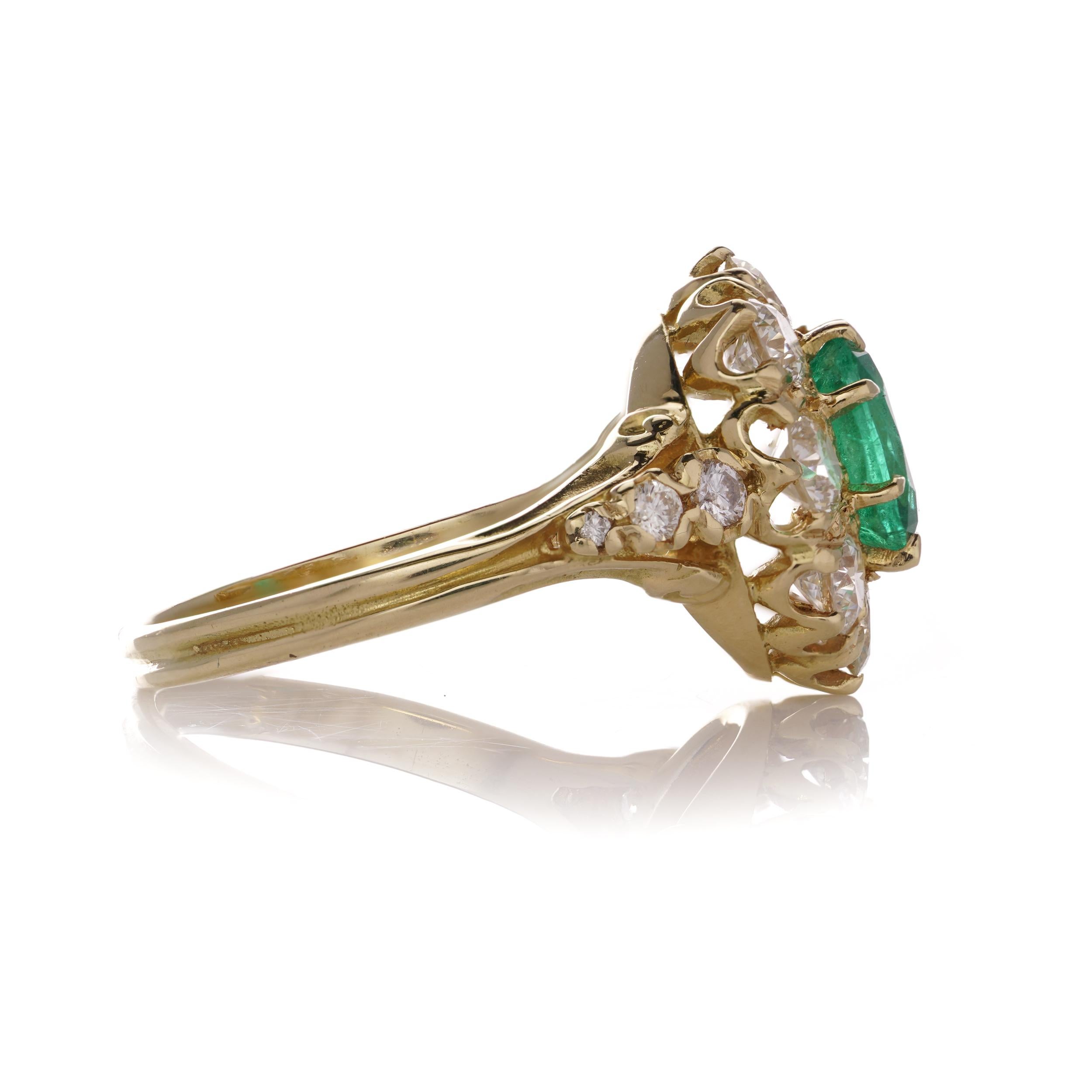 18kt.yellow gold 1.10 carat Oval Emerald Cluster ladies ring, surrounded by round 2.14 carats of brilliant diamonds. 
Hallmarked for  18kt. gold.

Dimensions - 
Ring size: 2.6 x 2.1 x 1.4 cm  
Finger Size (UK) = N 1/2 (US) = 7.25 (EU) =55 1/2