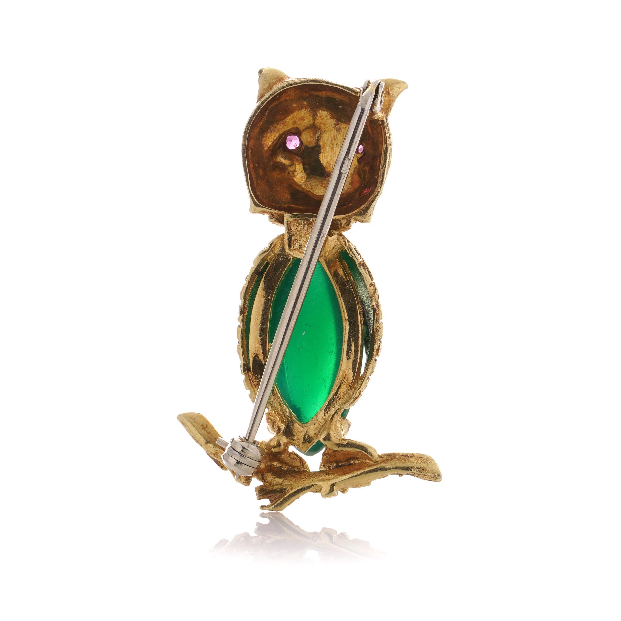 Women's or Men's 18kt gold owl brooch standing on a branch with coloured glass body and ruby eyes For Sale
