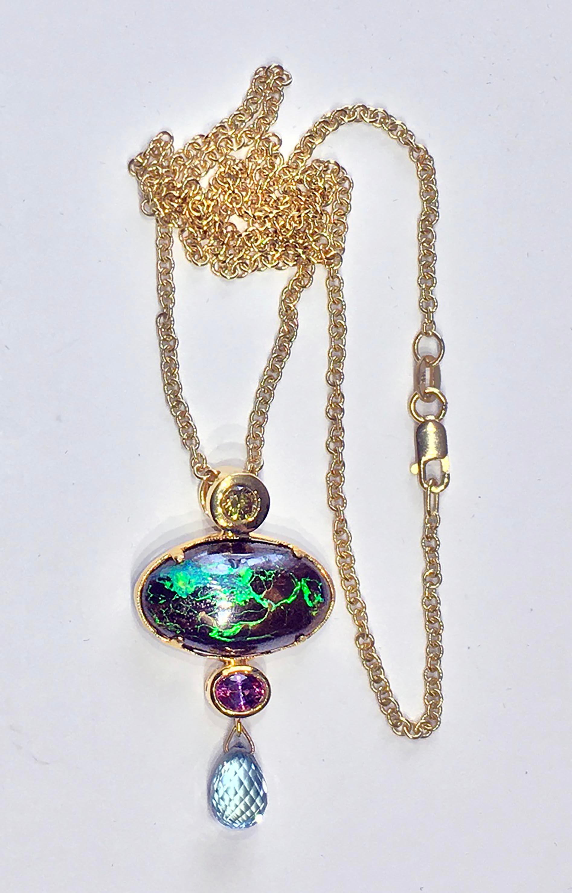 18kt Gold Pendant set with a Yellow Diamond, an Australian Boulder Opal, a Pink Oval Sapphire & a Teal Sapphire Briolette. This pendant is hung on an 18 inch 18kt Gold link chain with a Lobster Claw Clasp. the Fancy Yellow Diamond is 0.17 Carats,