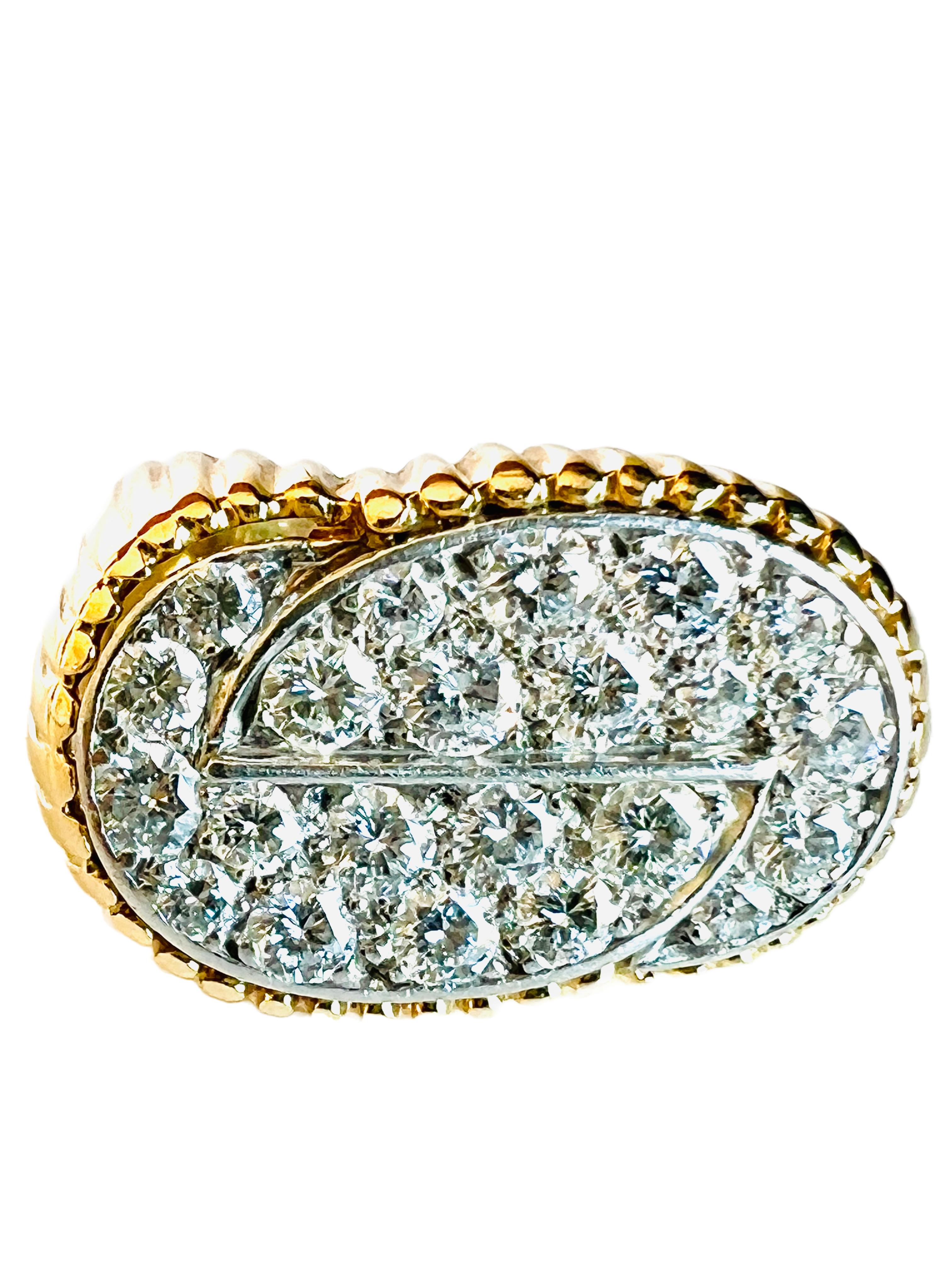 This elegant vintage ring is designed with two interlocking circular sections of pave diamonds set in platinum (top) and a ribbed pattern of 18k yellow gold for the shoulders and shank. 

This ring is very well-constructed with fine craftsmanship.
