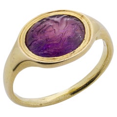 18kt. gold Roman intaglio amethyst ring with Eros riding on a dolphin 